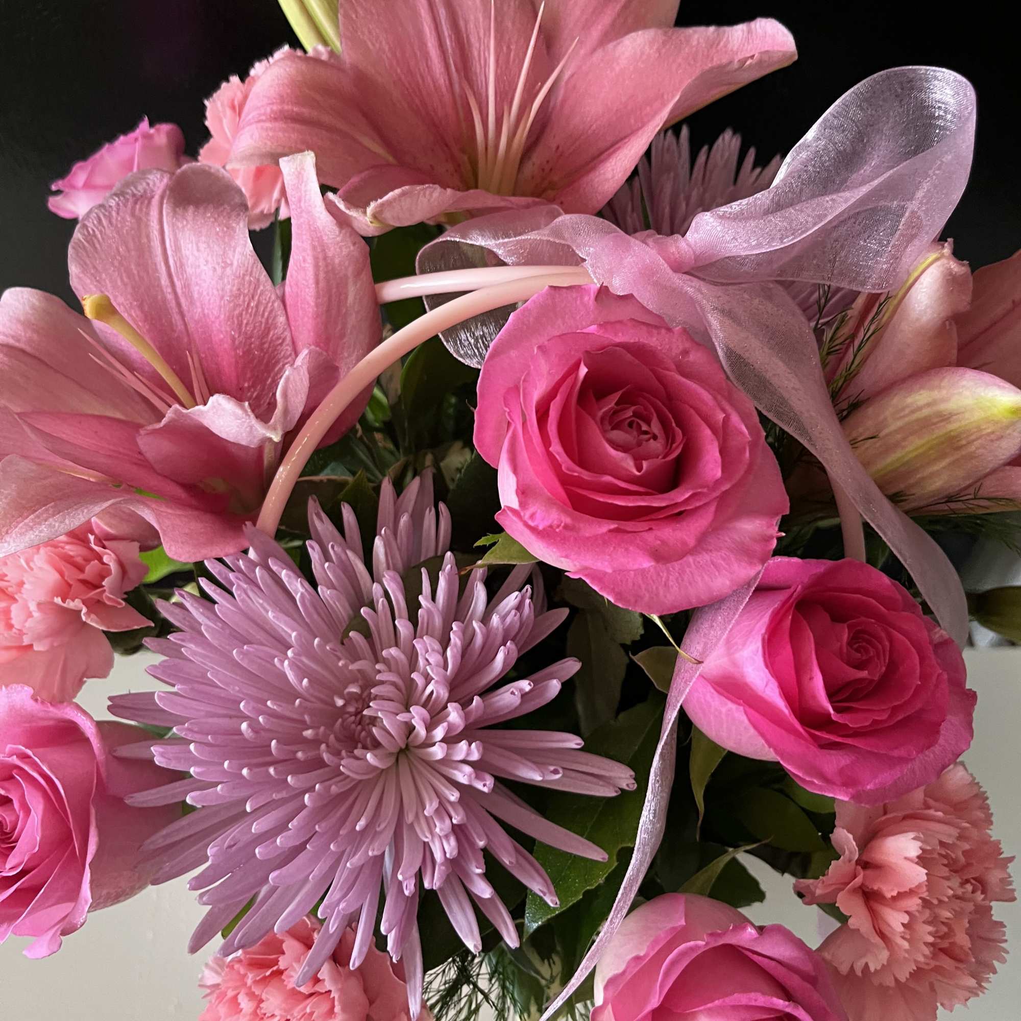 fresh pink flowers in basket 
Other colors available 