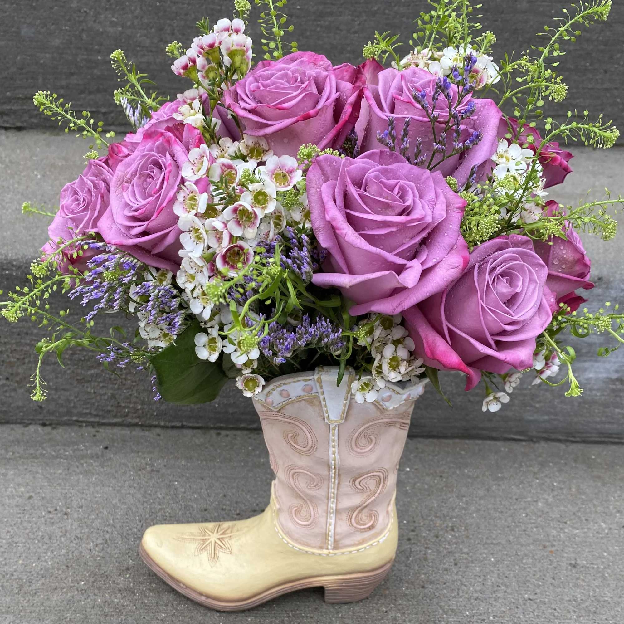 A Dozen Lavender Roses with accent flowers in a Pink and Beige