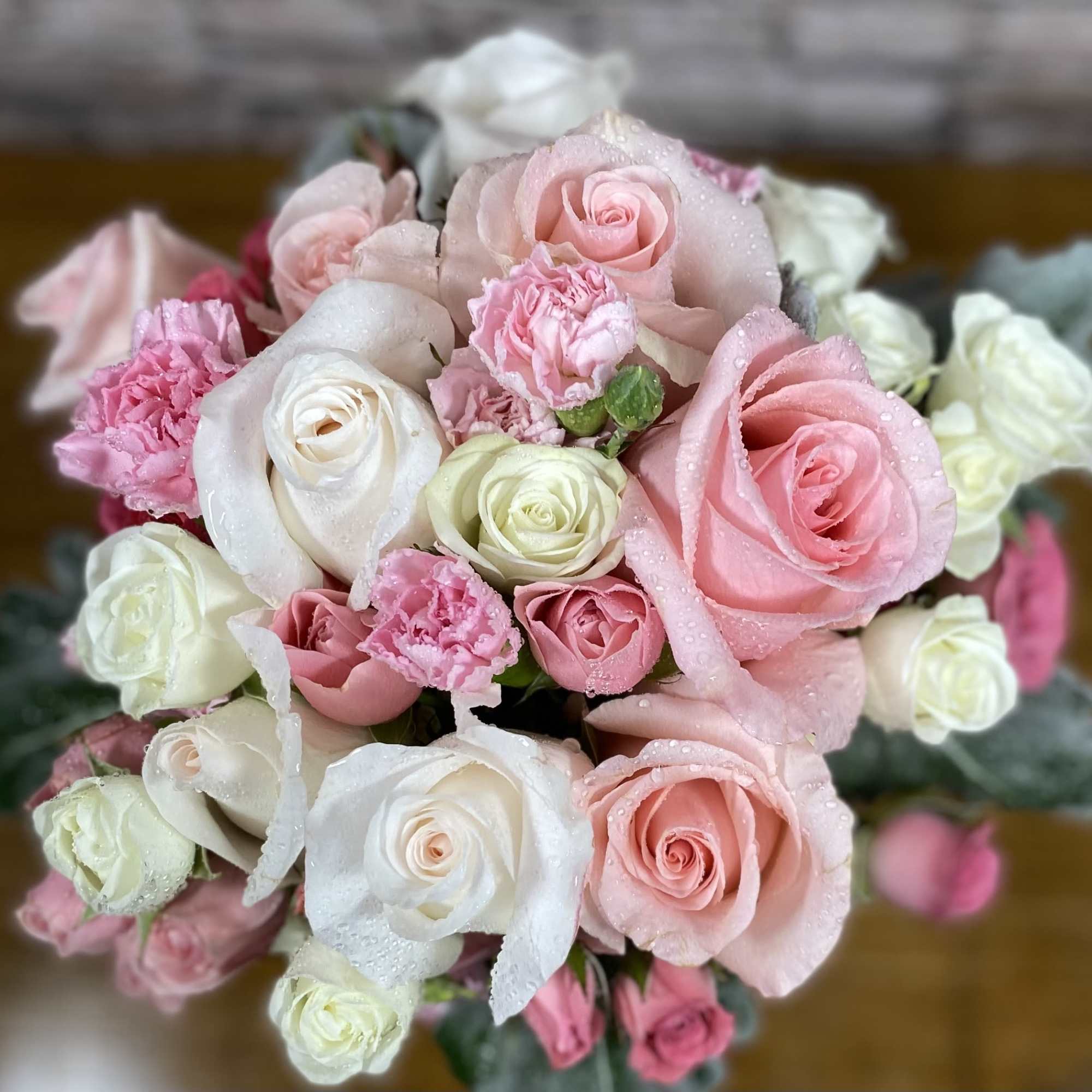 An assortment of pink and white roses, spray roses with complementary flowers