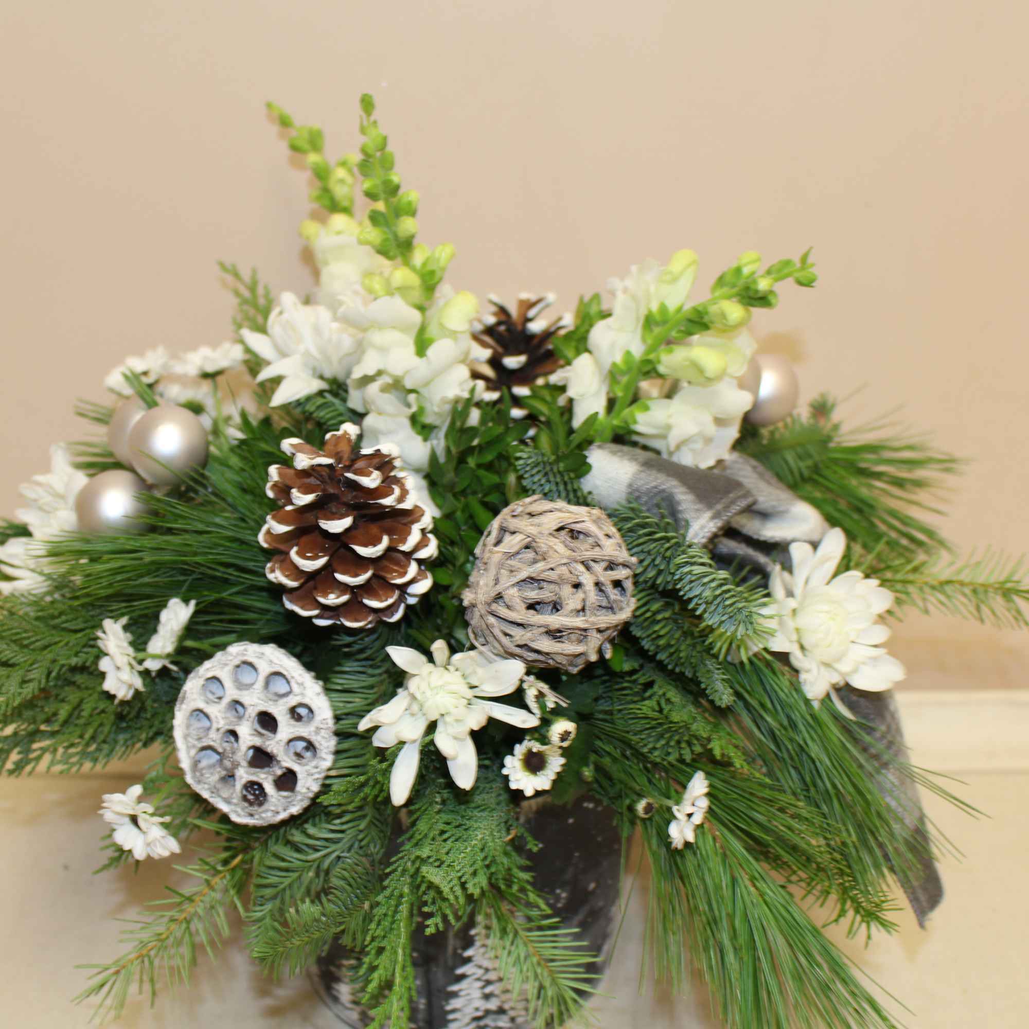 A beautiful holiday arrangement in a galvanized tin with white trees engraved