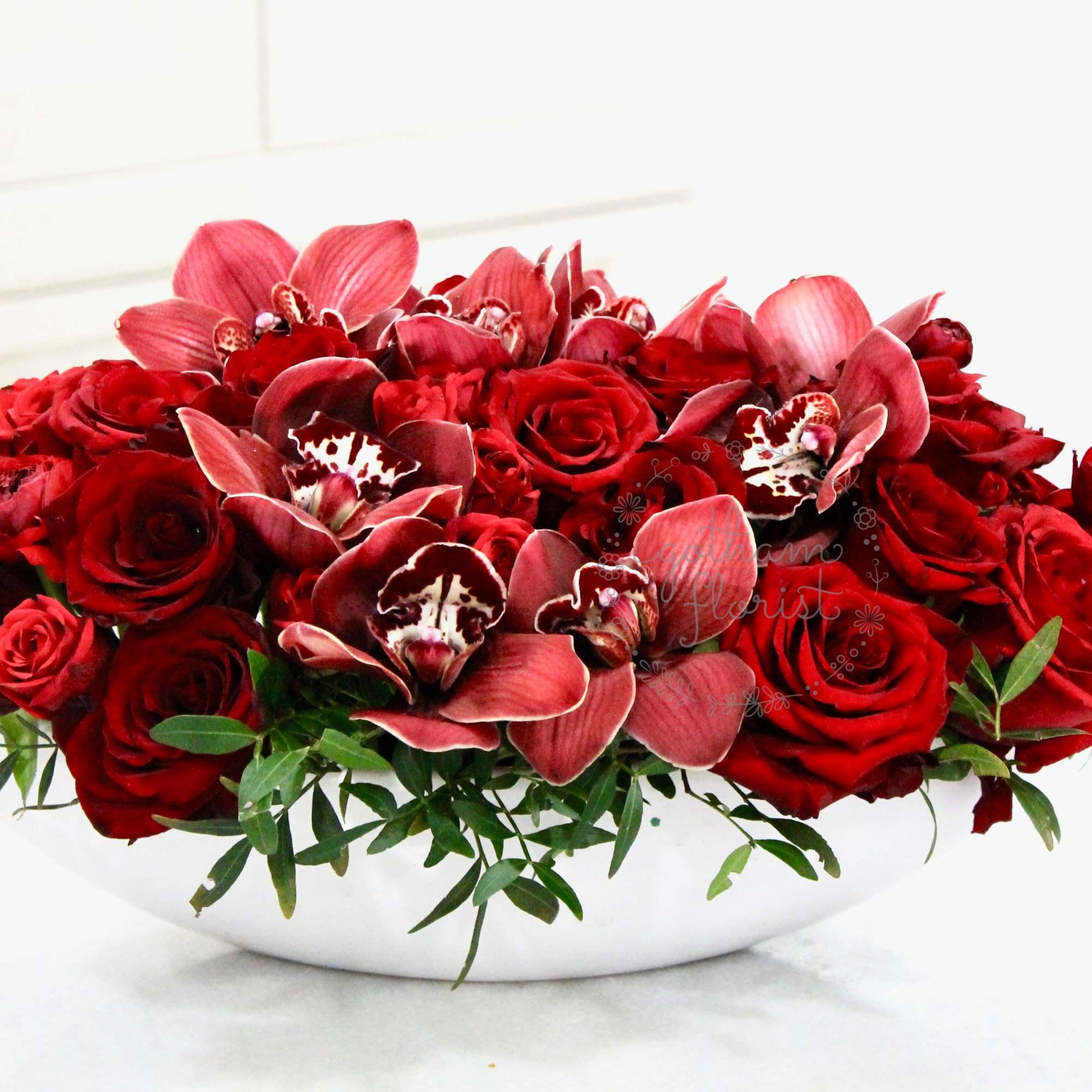3 dozen roses with orchids. A gorgeous modern design. Send the best