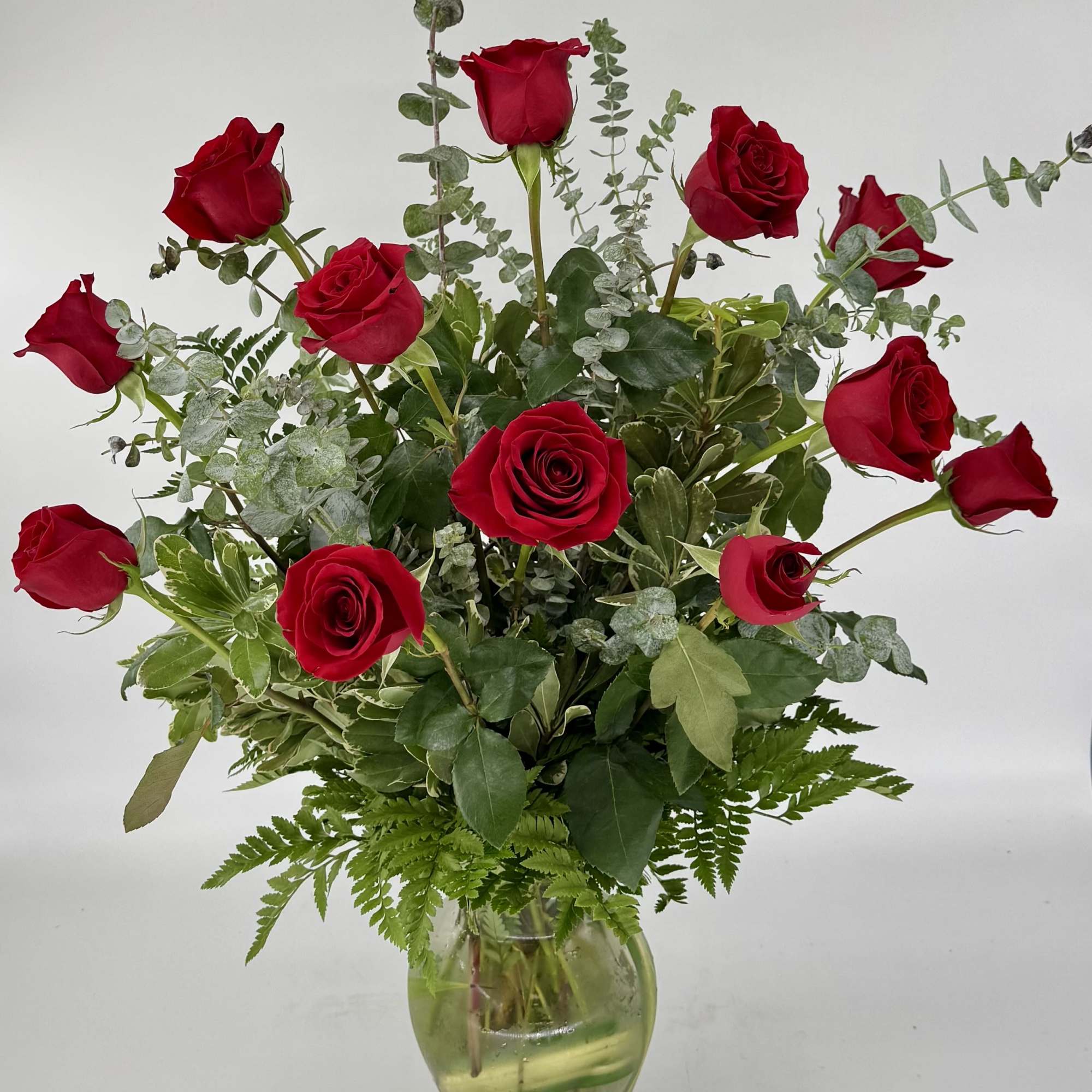 Immerse your loved one in timeless elegance with a dozen long-stemmed red