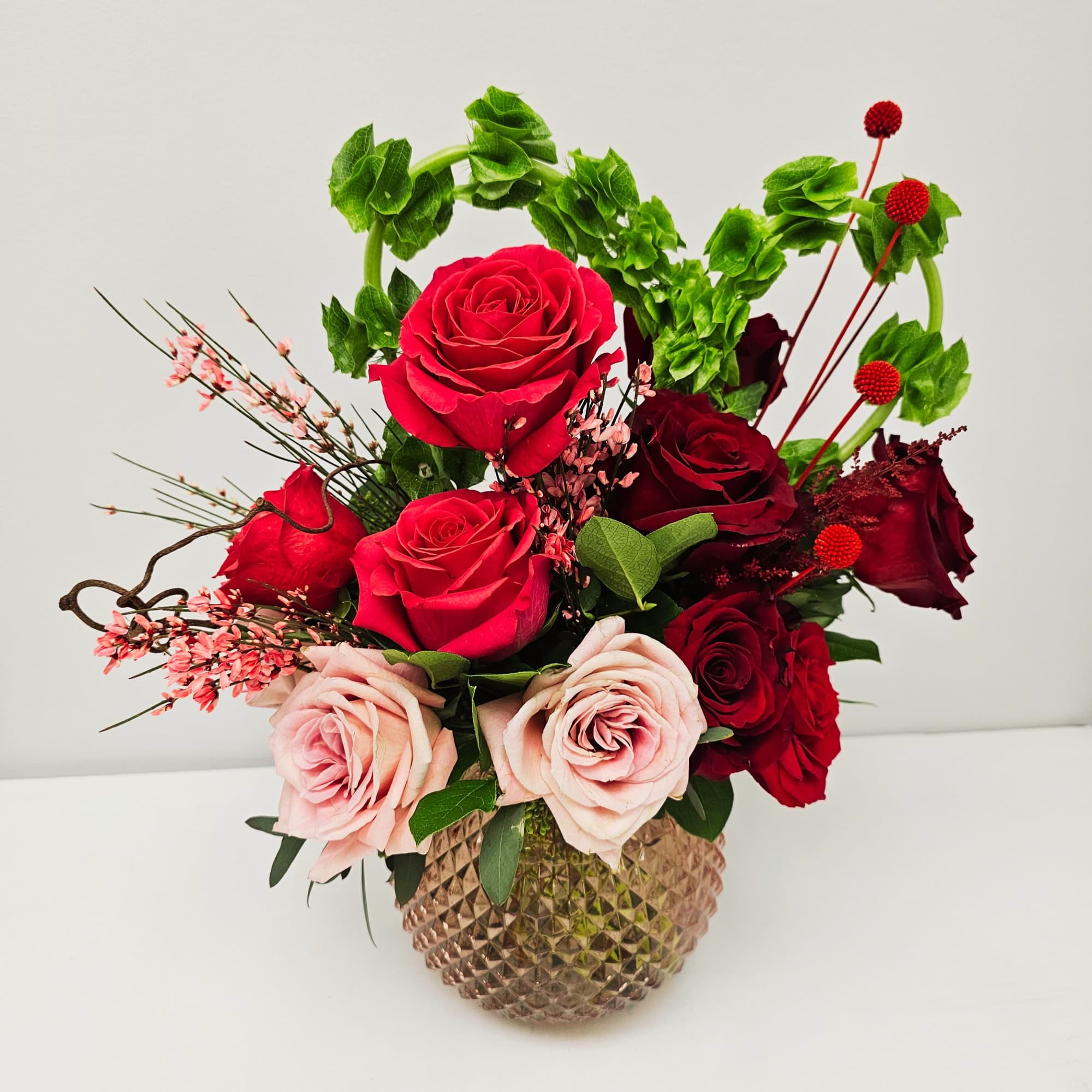 Mixed rose whimsical arrangement with pink and red roses, perfect for any