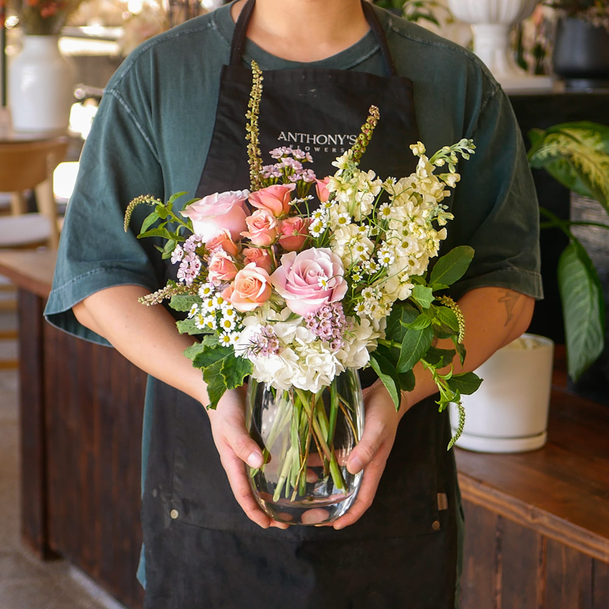 This enchanting arrangement features a soft colorful palette of roses, stock, hydrangeas