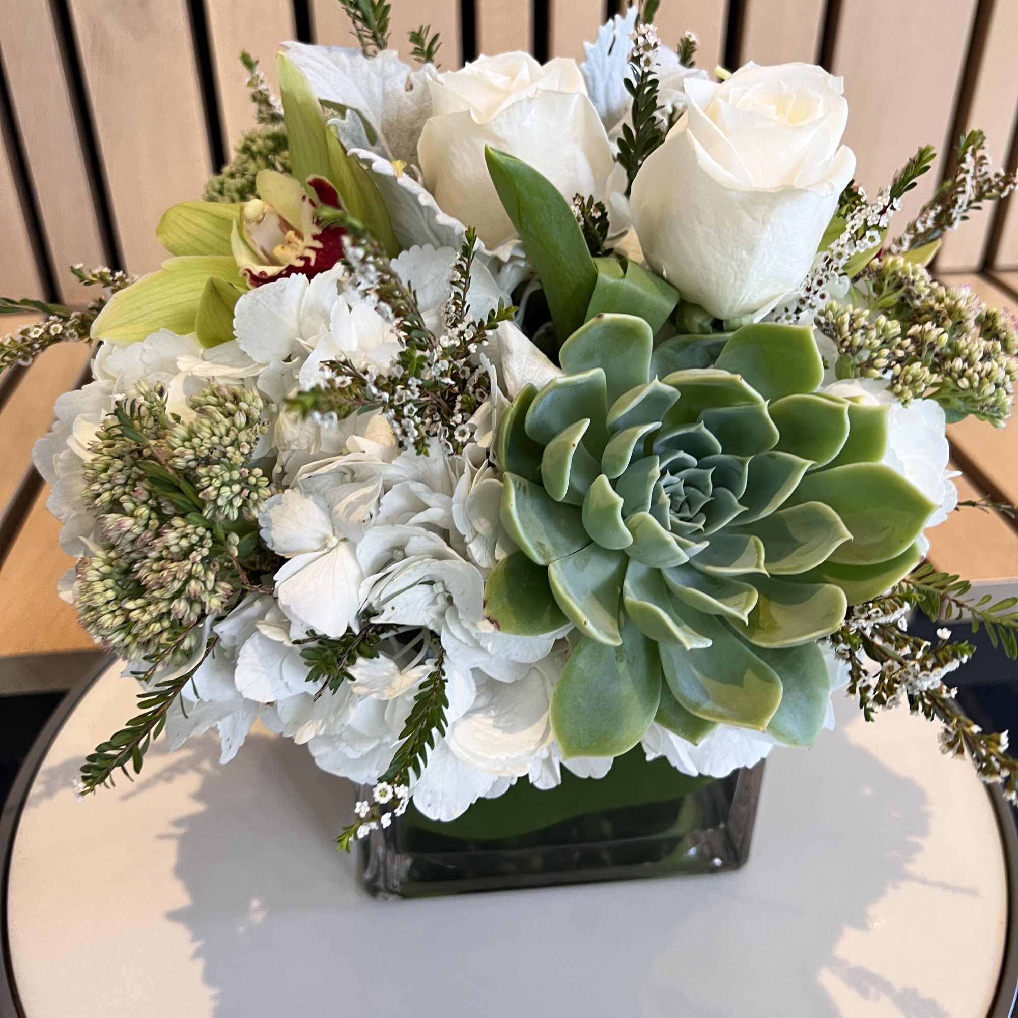 Execusite floral piece created with all natural element&#039;s succulents, greenery&rsquo;s premium cream