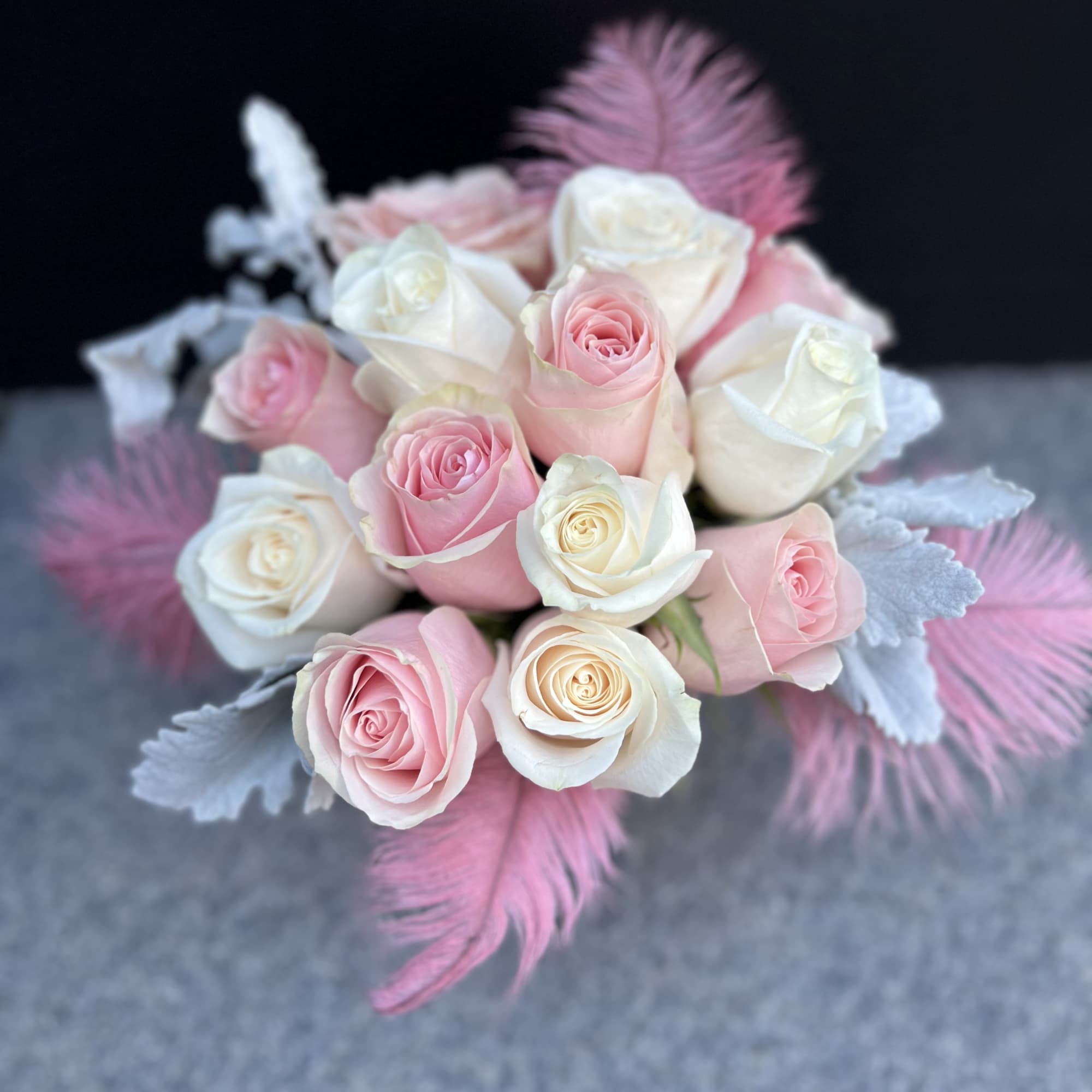 Combination of blush pink and cream roses set in a ceramic pot