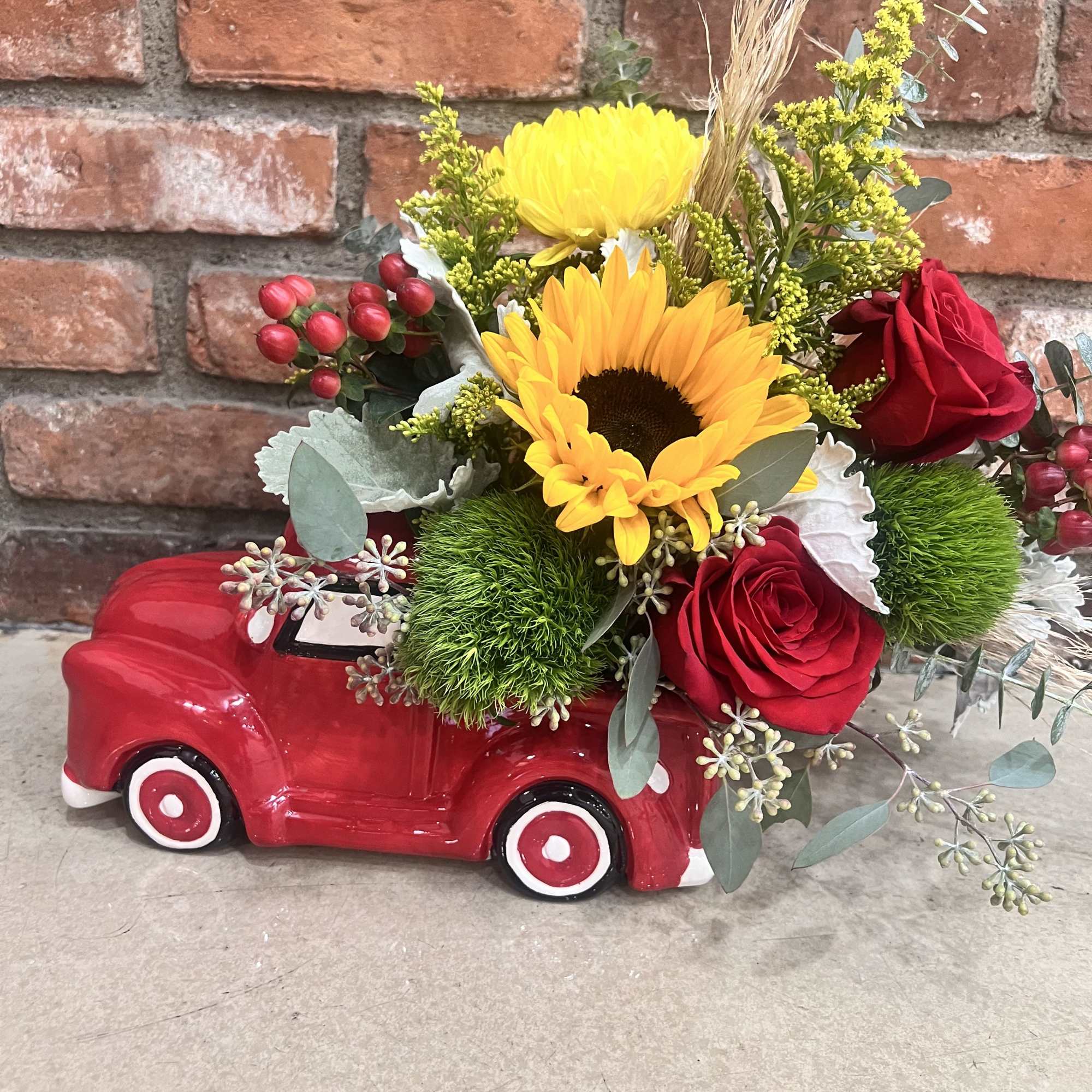A collective ceramic farmers red truck, 11&rdquo; long by 7&rdquo; tall 