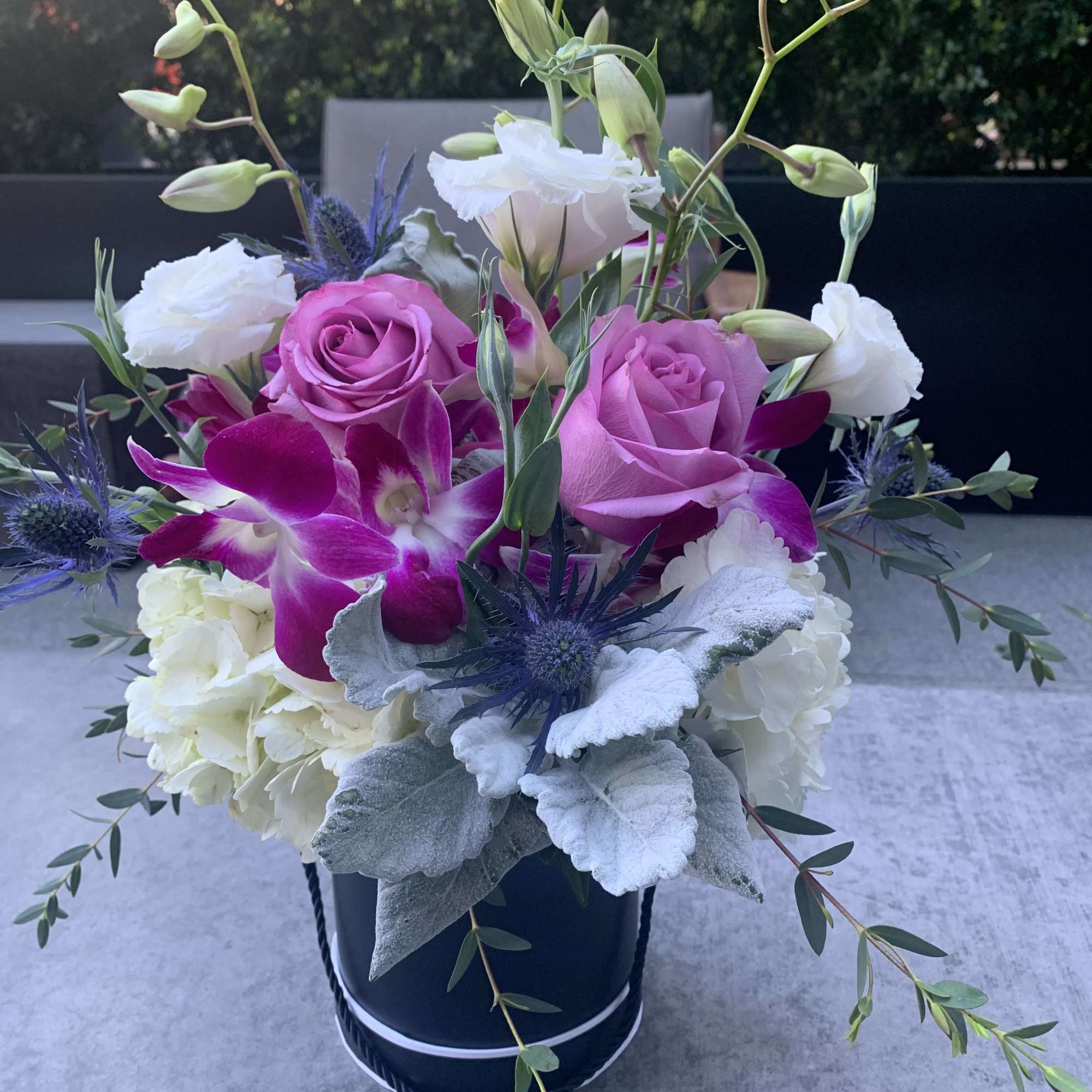 Ceramic Container filled with flowers roses, Hawaiian orchids, hydrangeas, dusty miller, Tiso