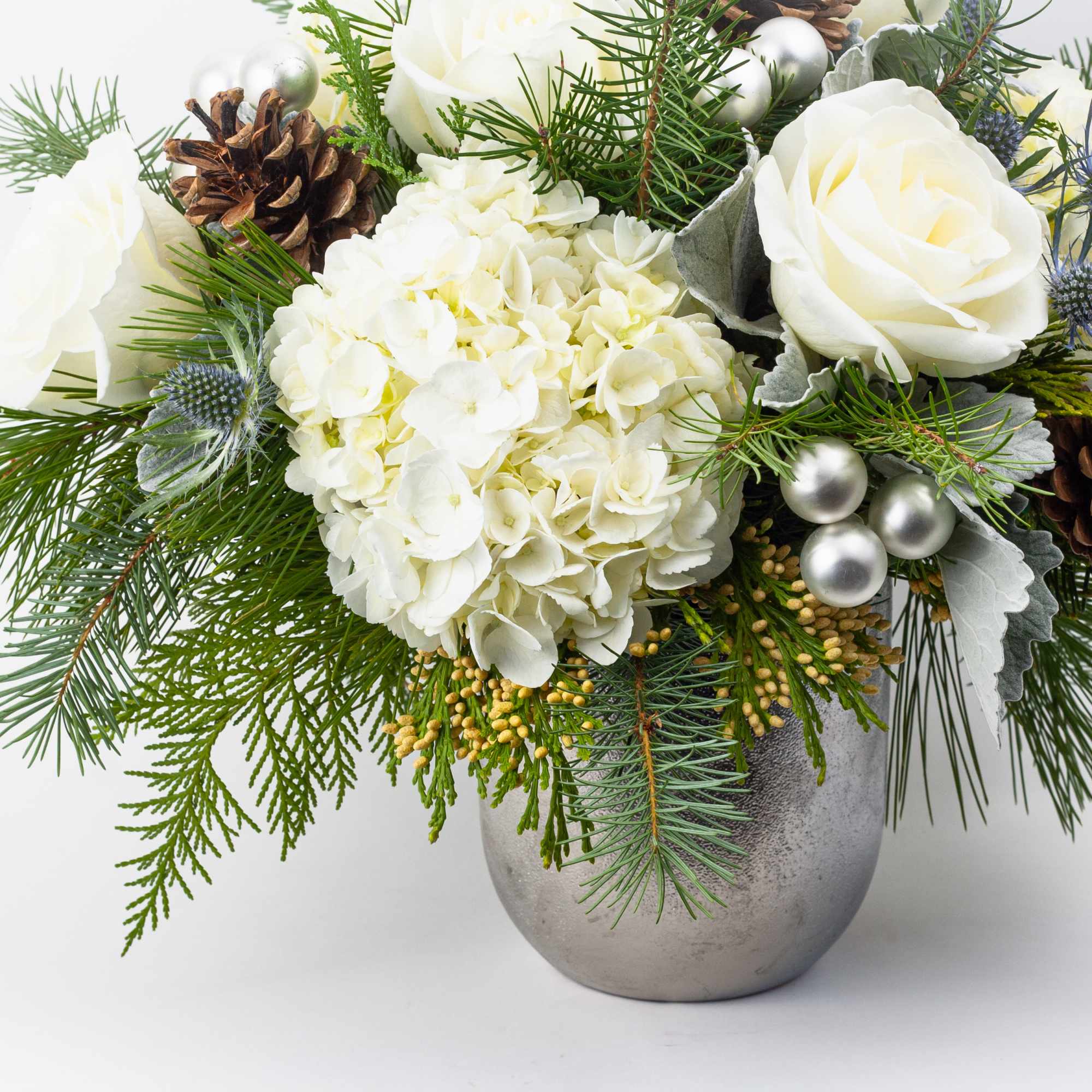 Earthy and natural. This warm and festive Christmas flower arrangement is simply