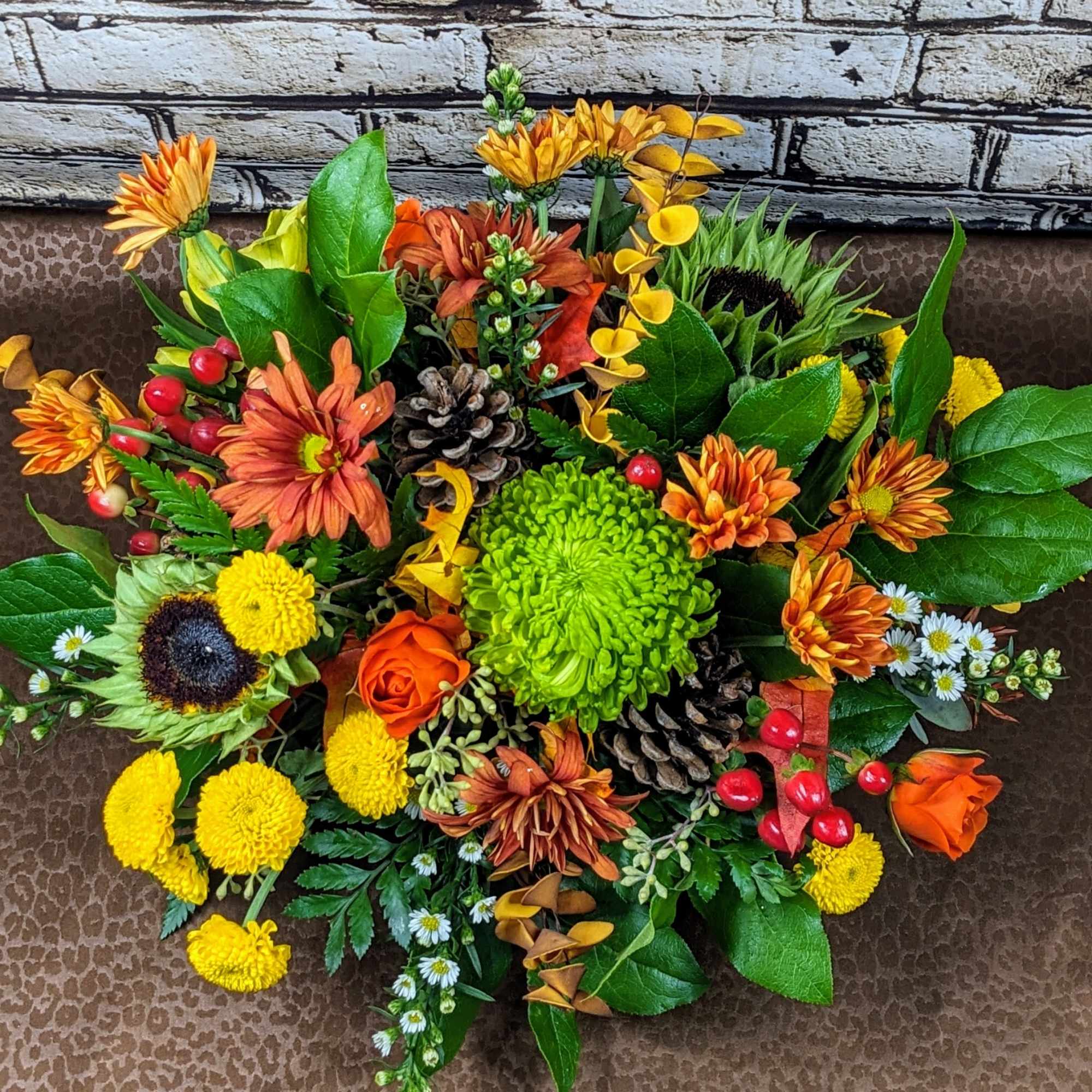 Our Lively Thanksgiving centerpiece features a harmonious mix of vibrant orange, green