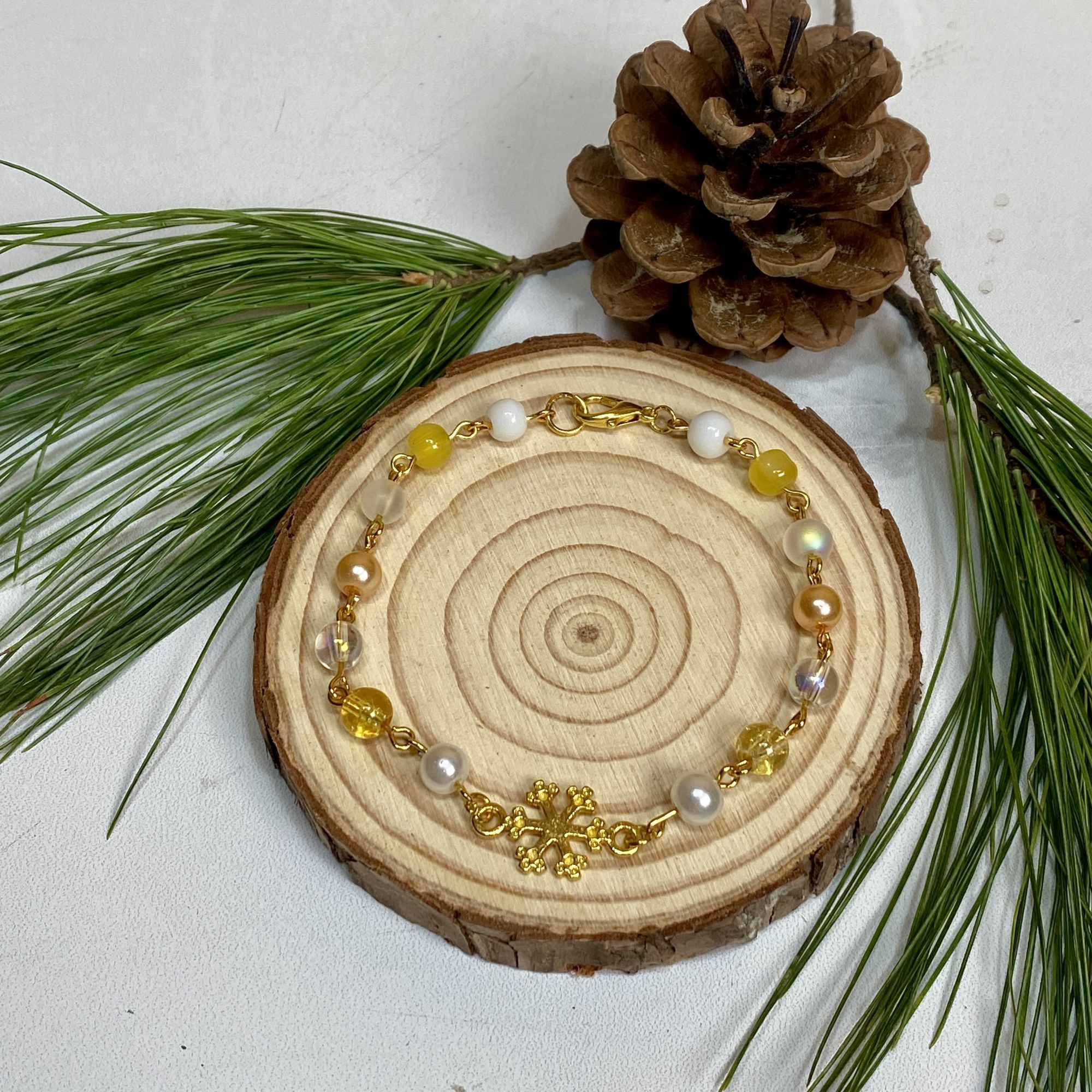 Our Golden Glimmer Snowflake Bracelet is the perfect way to spread some