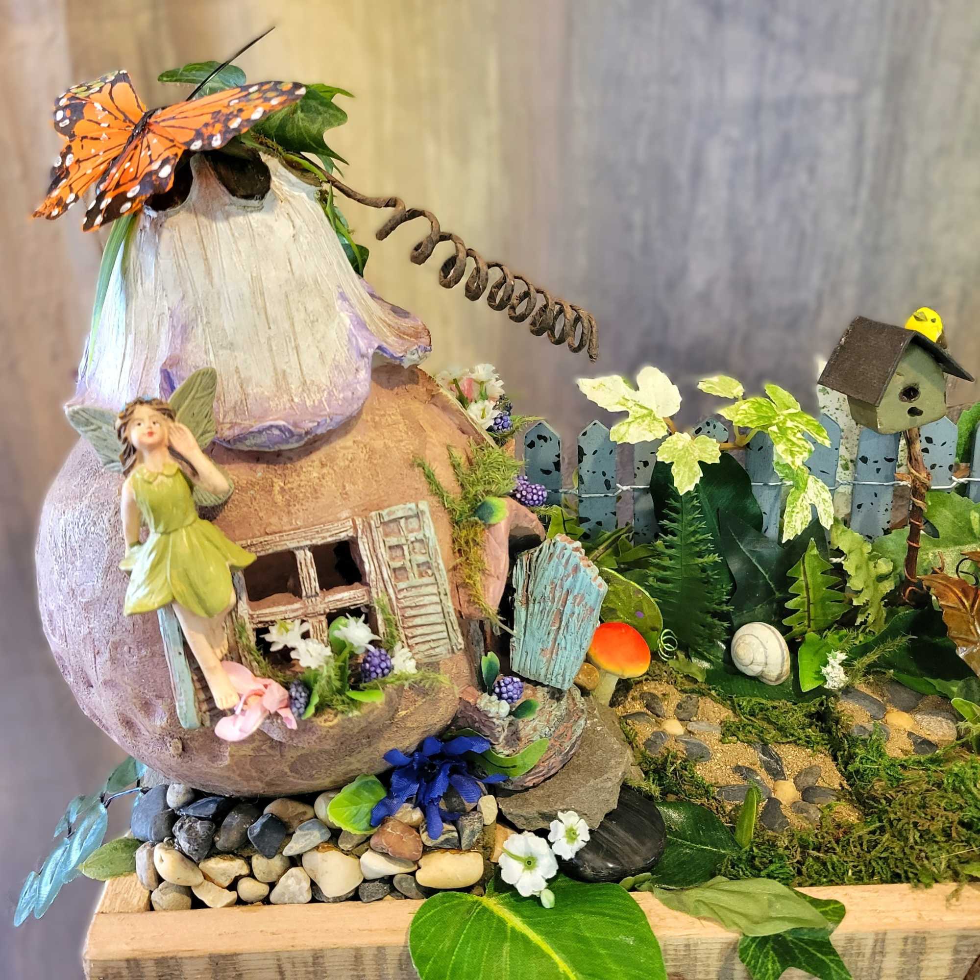 This artificial fairy garden contains multitudes! Examine it closer and find more