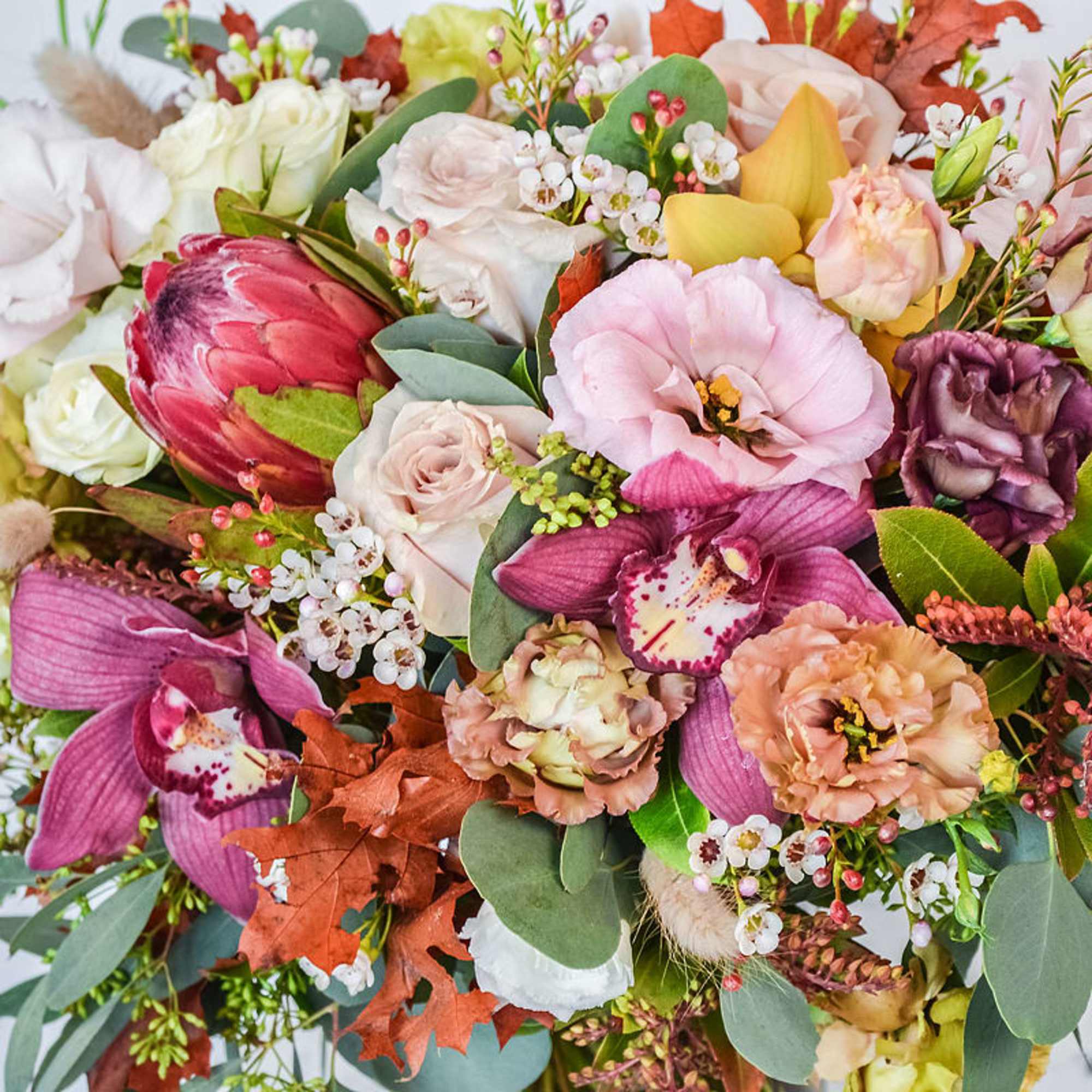 Celebrate the beauty of fall with our Seasonal Autumn Arrangement, a stunning