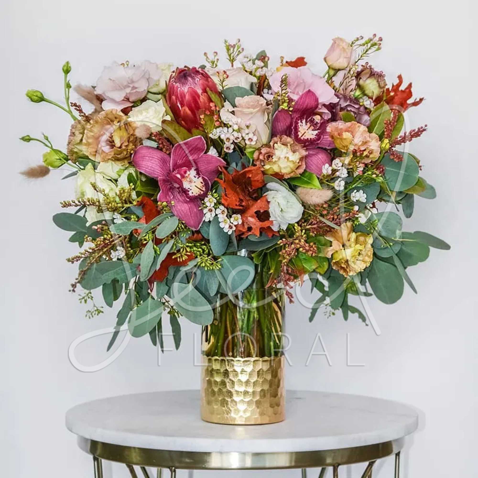 Celebrate the beauty of fall with our Seasonal Autumn Arrangement, a stunning