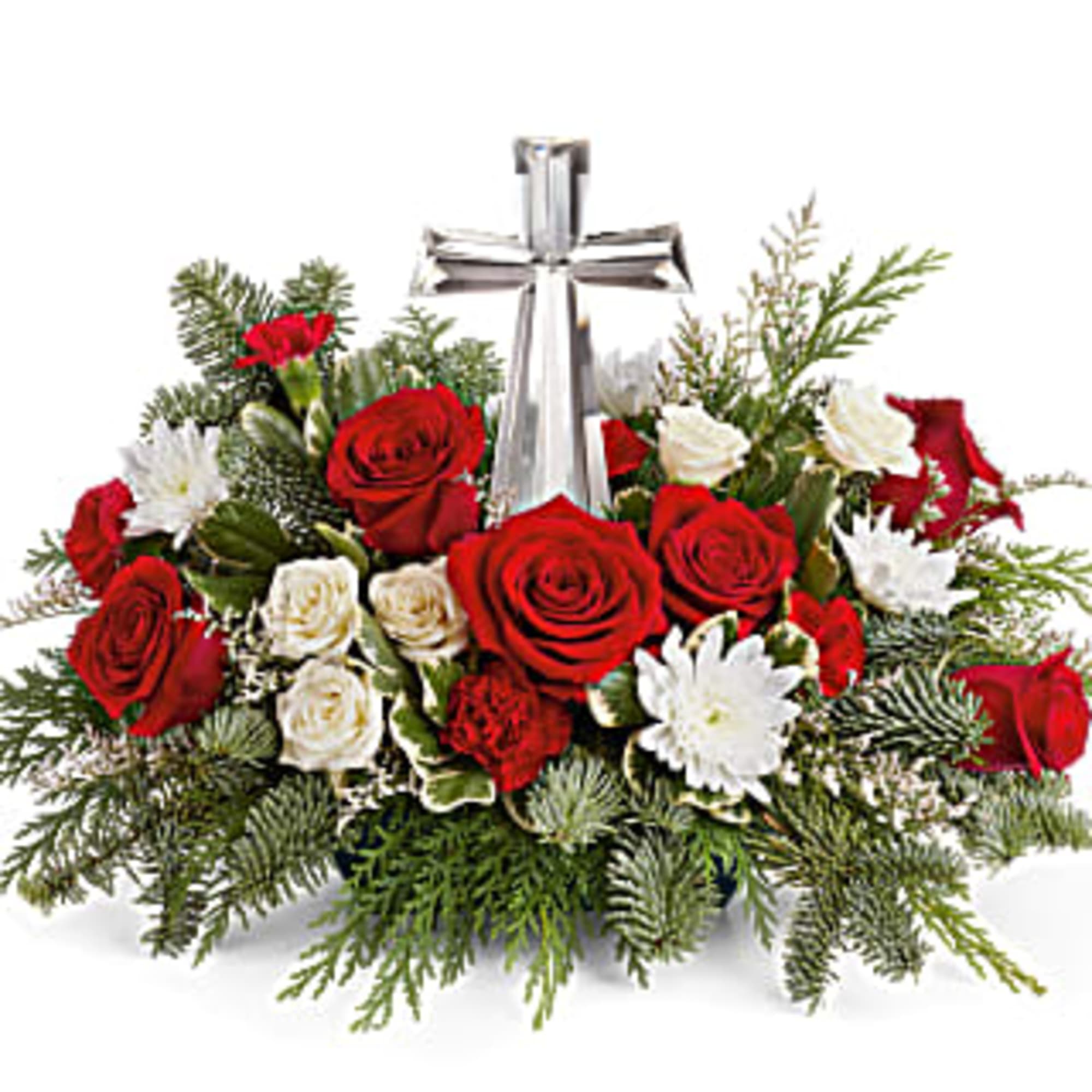 The crystal cross is nestled elegantly among red and white blooms, this