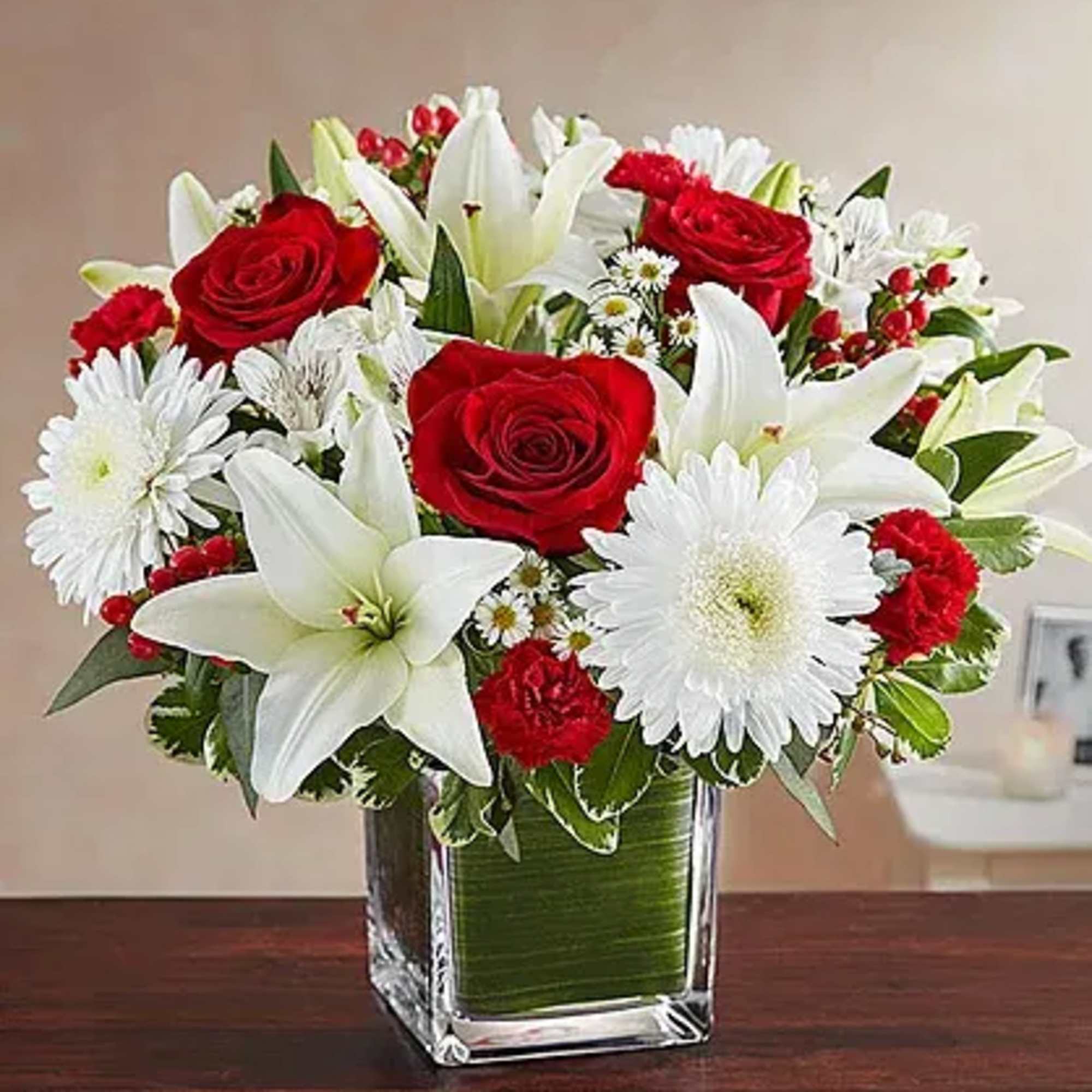 Arrangement of white roses, Asiatic lilies, football mums, snapdragon, daisy poms and