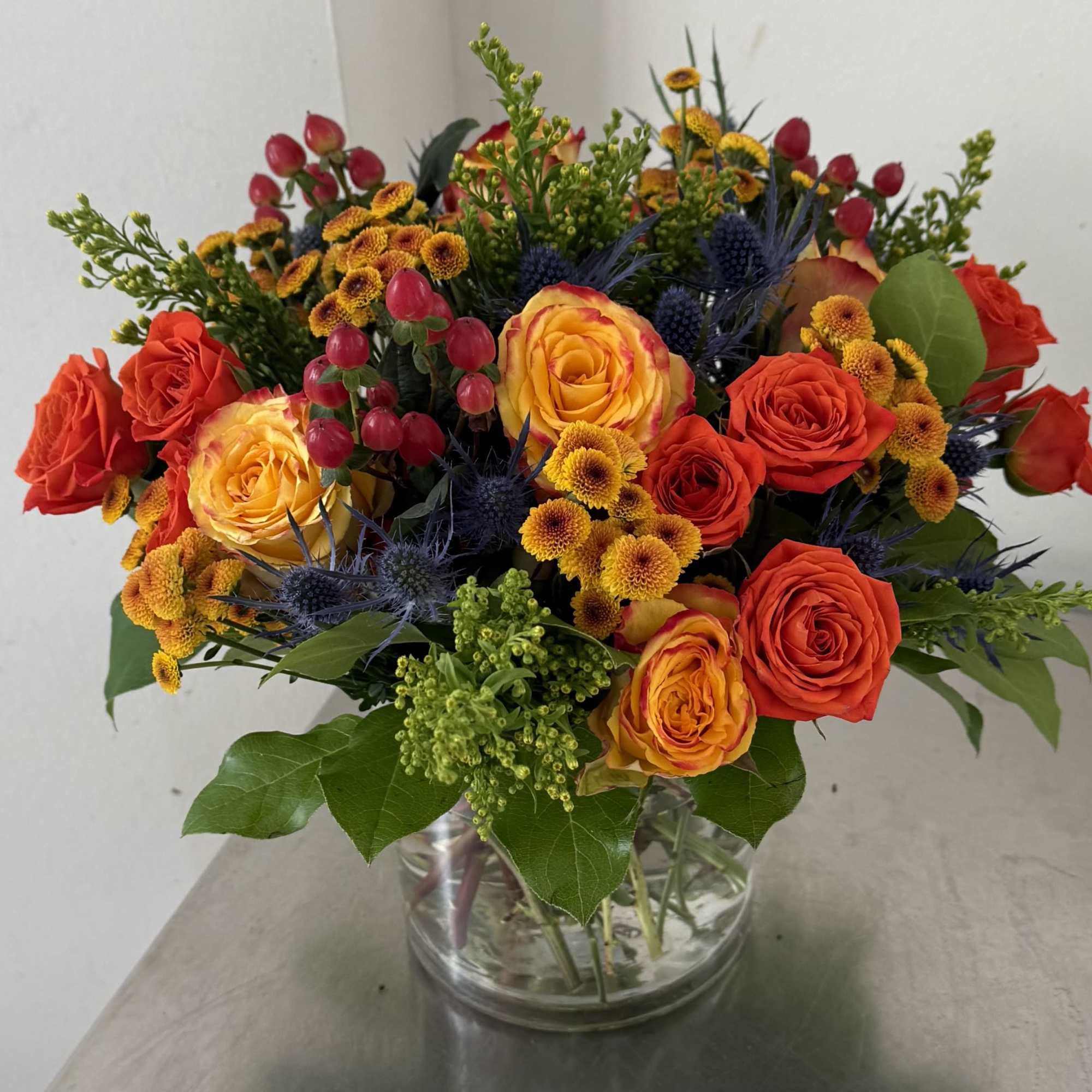 Bring the beauty of fall indoors with our lush seasonal arrangement designed