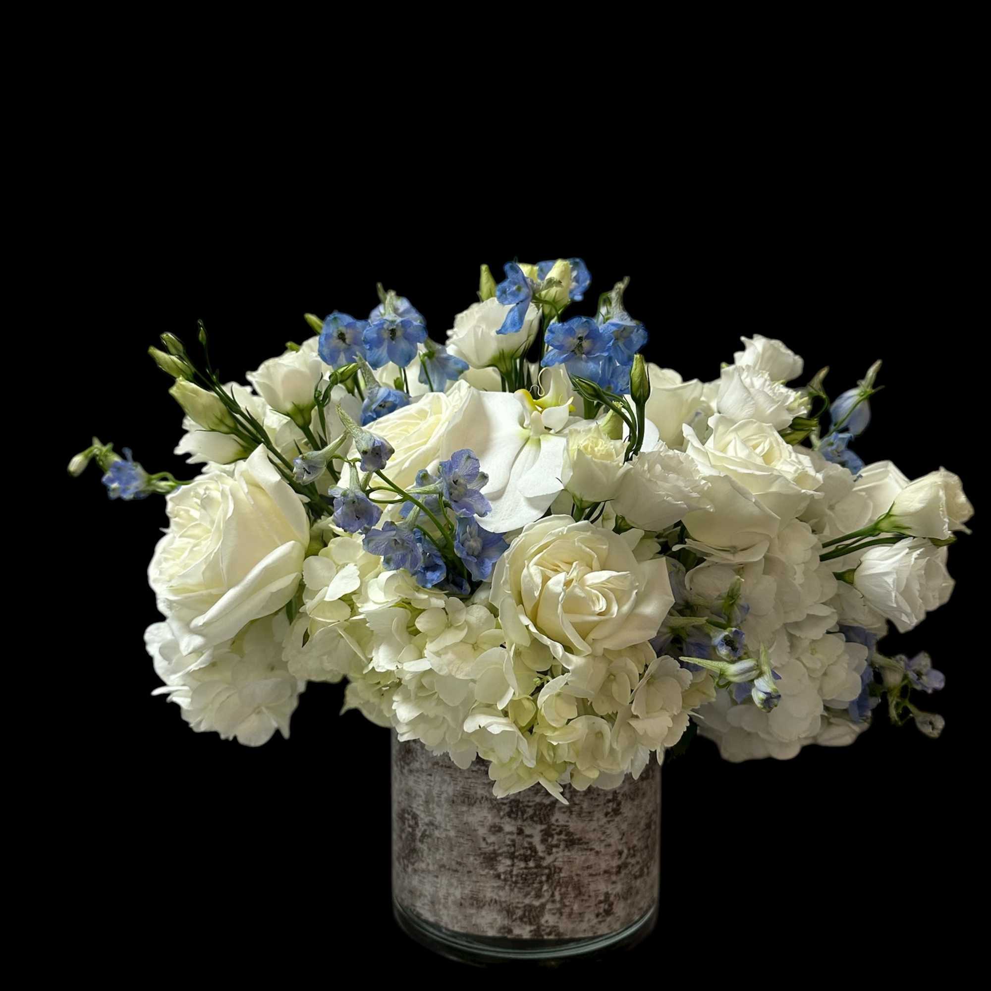 White hydrangea accompanied by a small touch of blue Delphinium along with