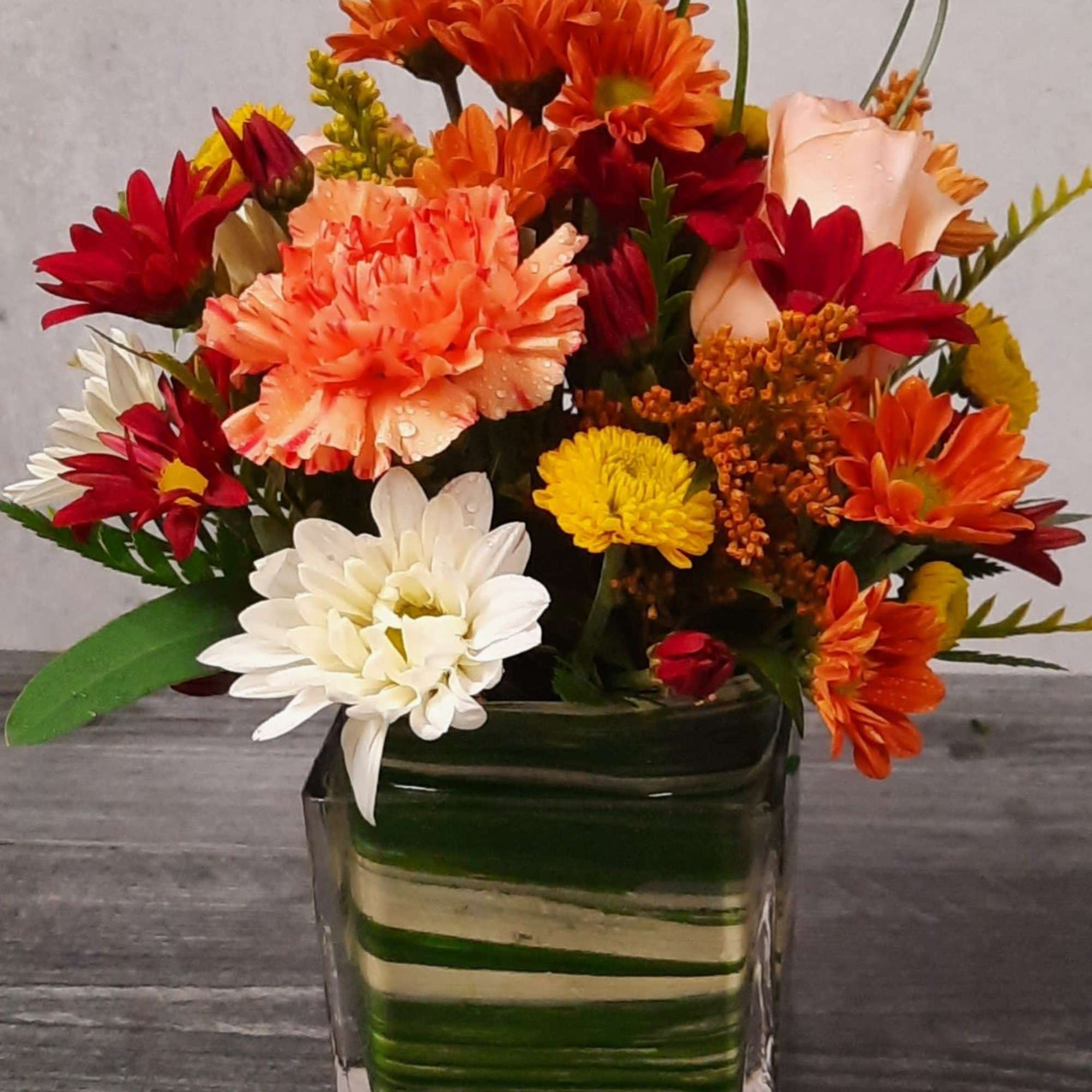 Delight someone special, including yourself, today! Featuring in season roses, Gerbera daisy