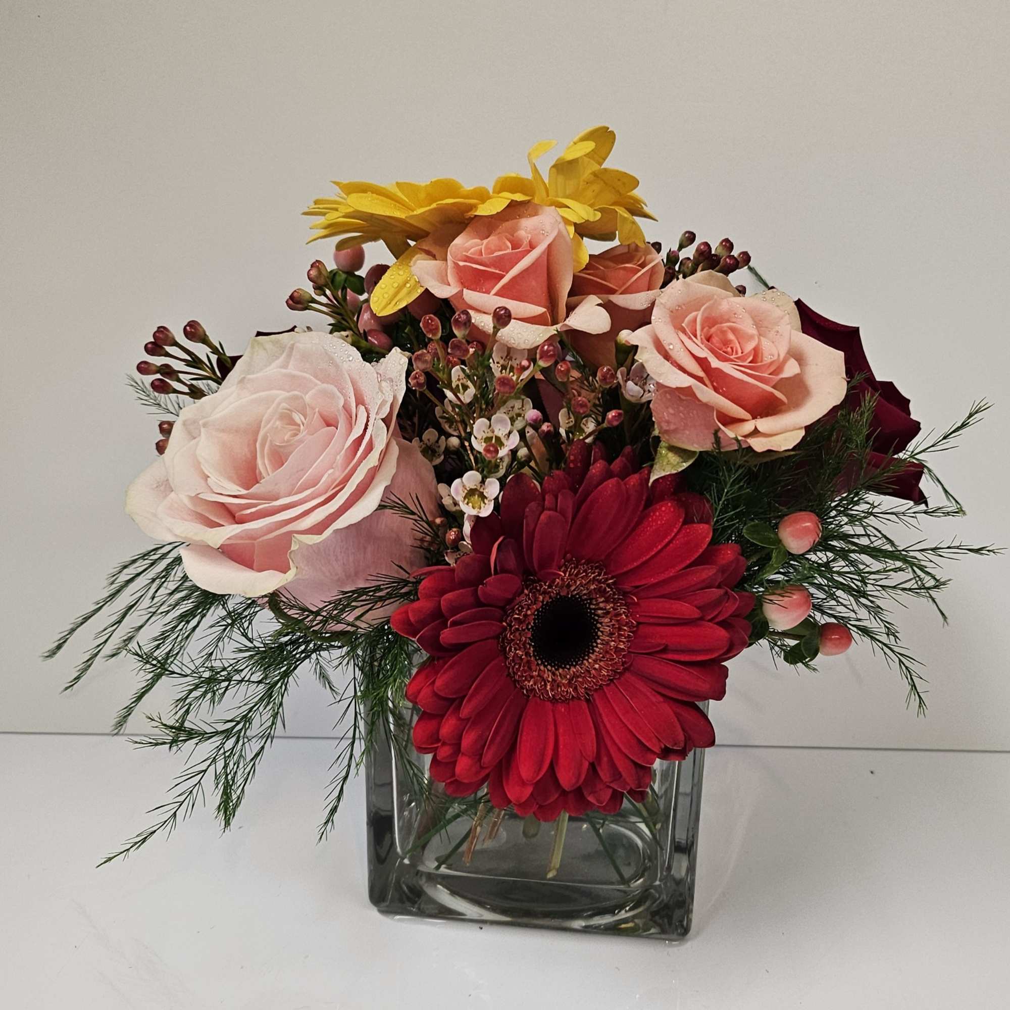 Delight someone special, including yourself, today! Featuring in season roses, Gerbera daisy