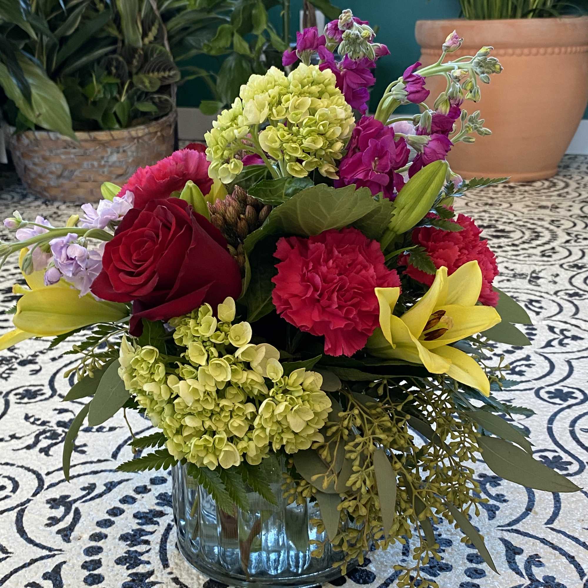 This arrangement includes roses, green hydrangea, seasonal flowers with beautiful filler. Spring