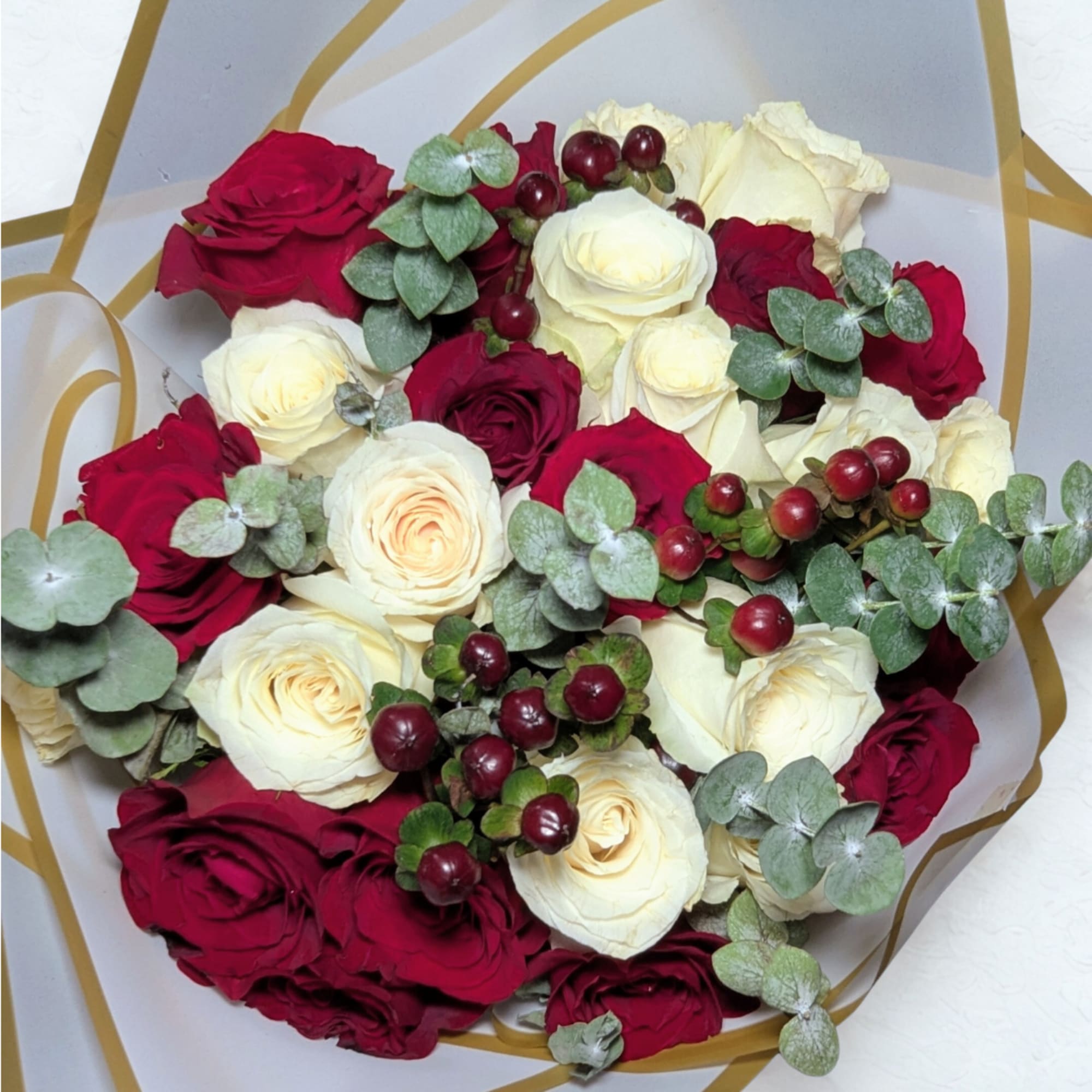 A beautiful hand-tied bouquet featuring 24 premium red and white roses, accented