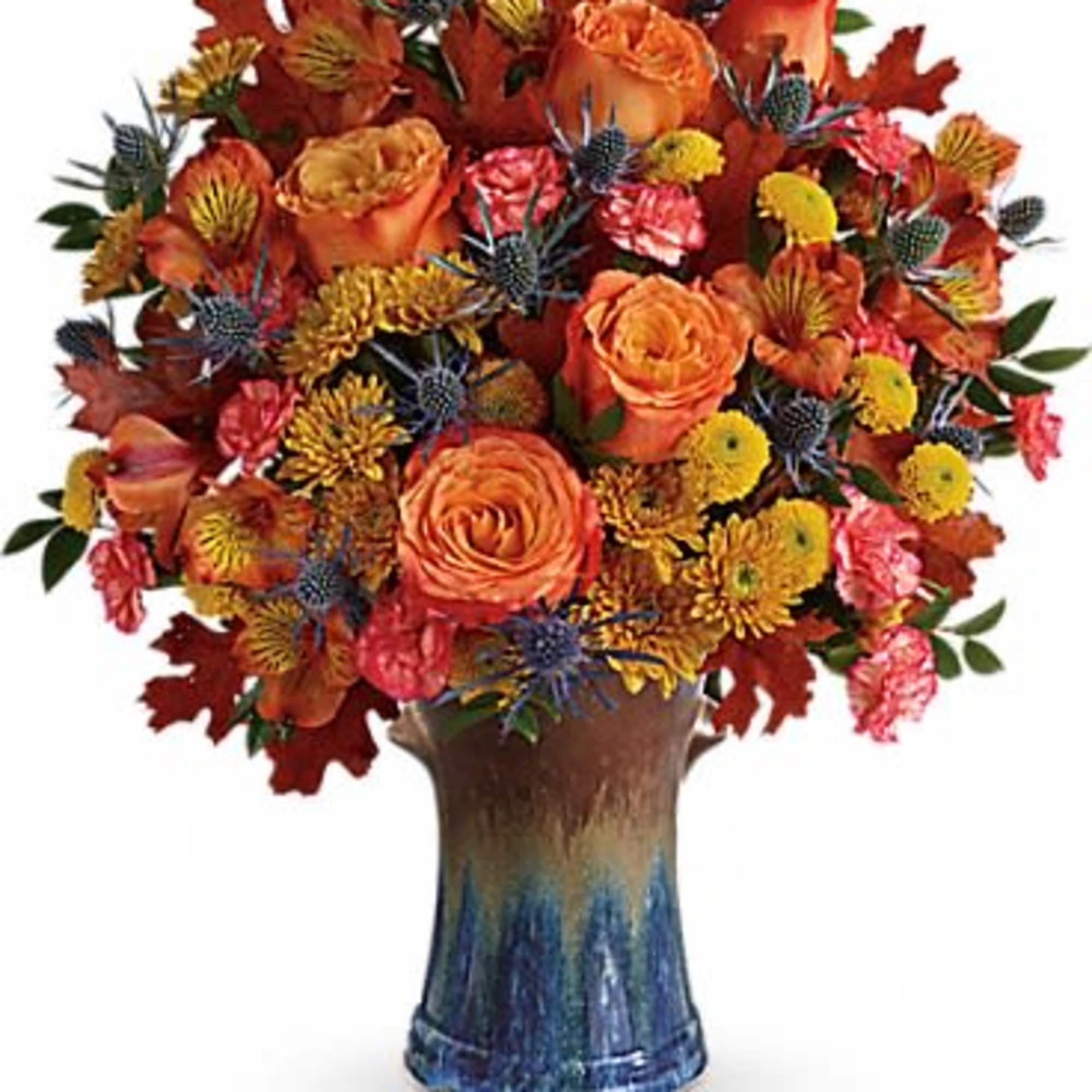 Classic fall colors and a stunning stoneware vase make this arrangement an