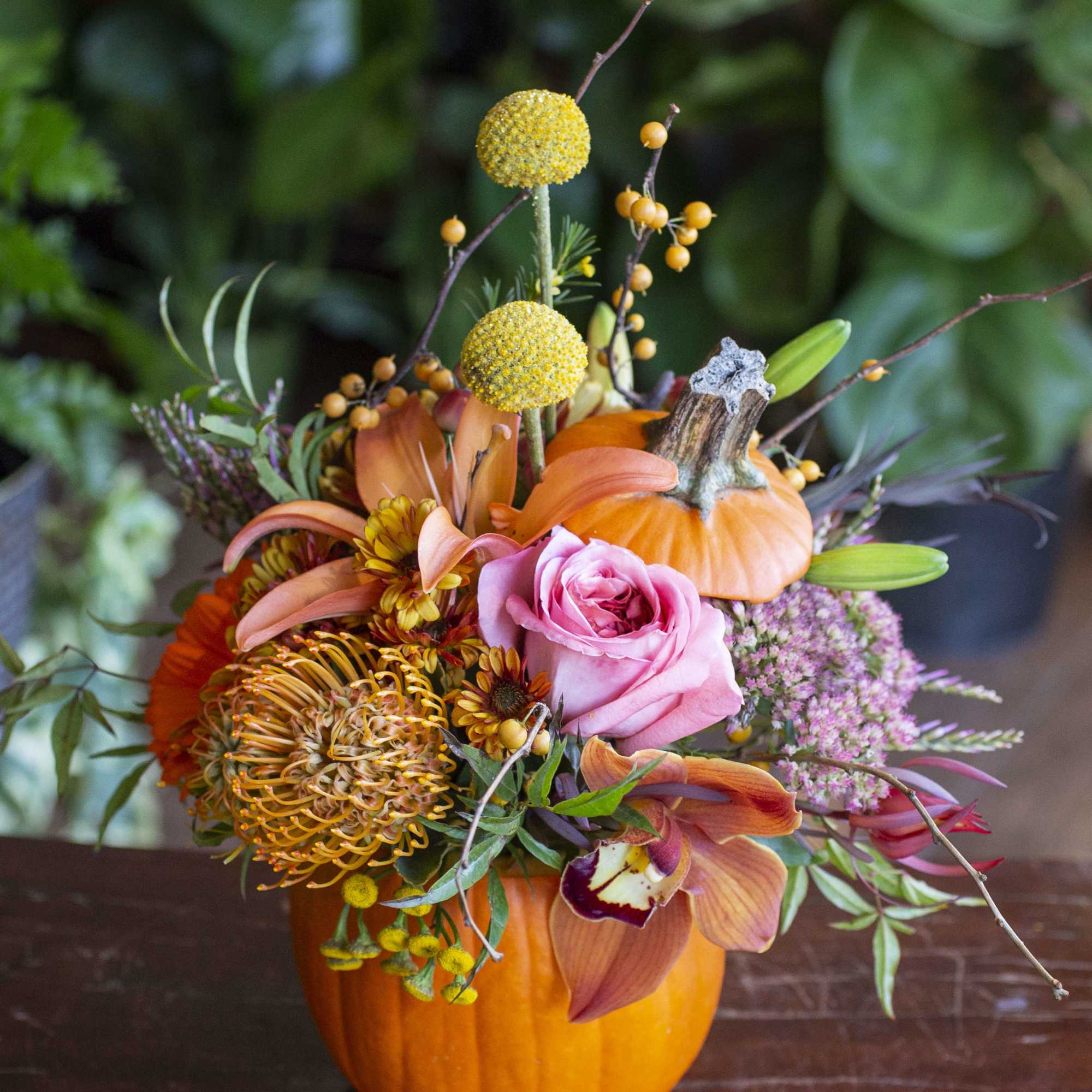 Next level pumpkin carving... real pumpkin full of beautiful blooms. If you