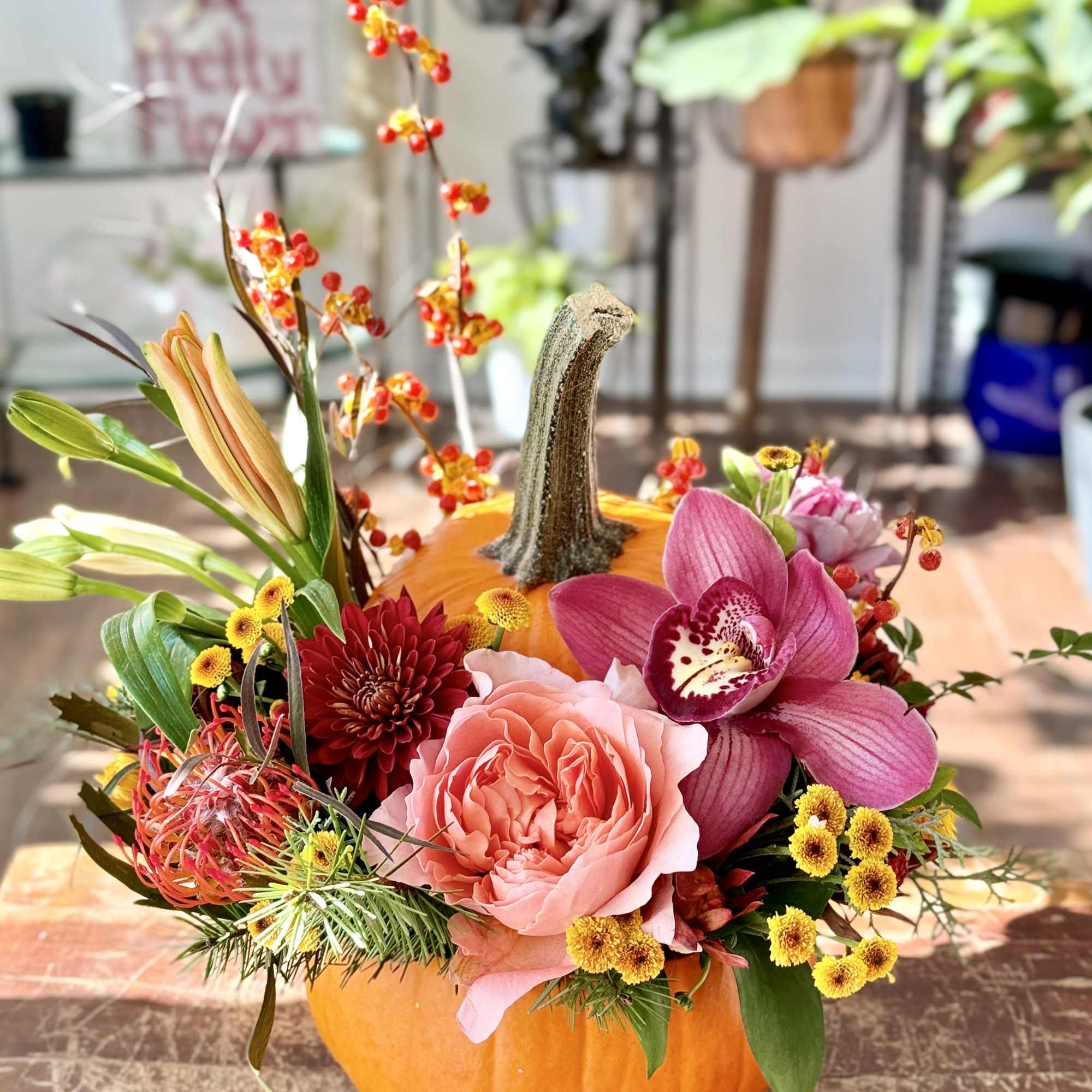 Next level pumpkin carving... real pumpkin full of beautiful blooms. If you