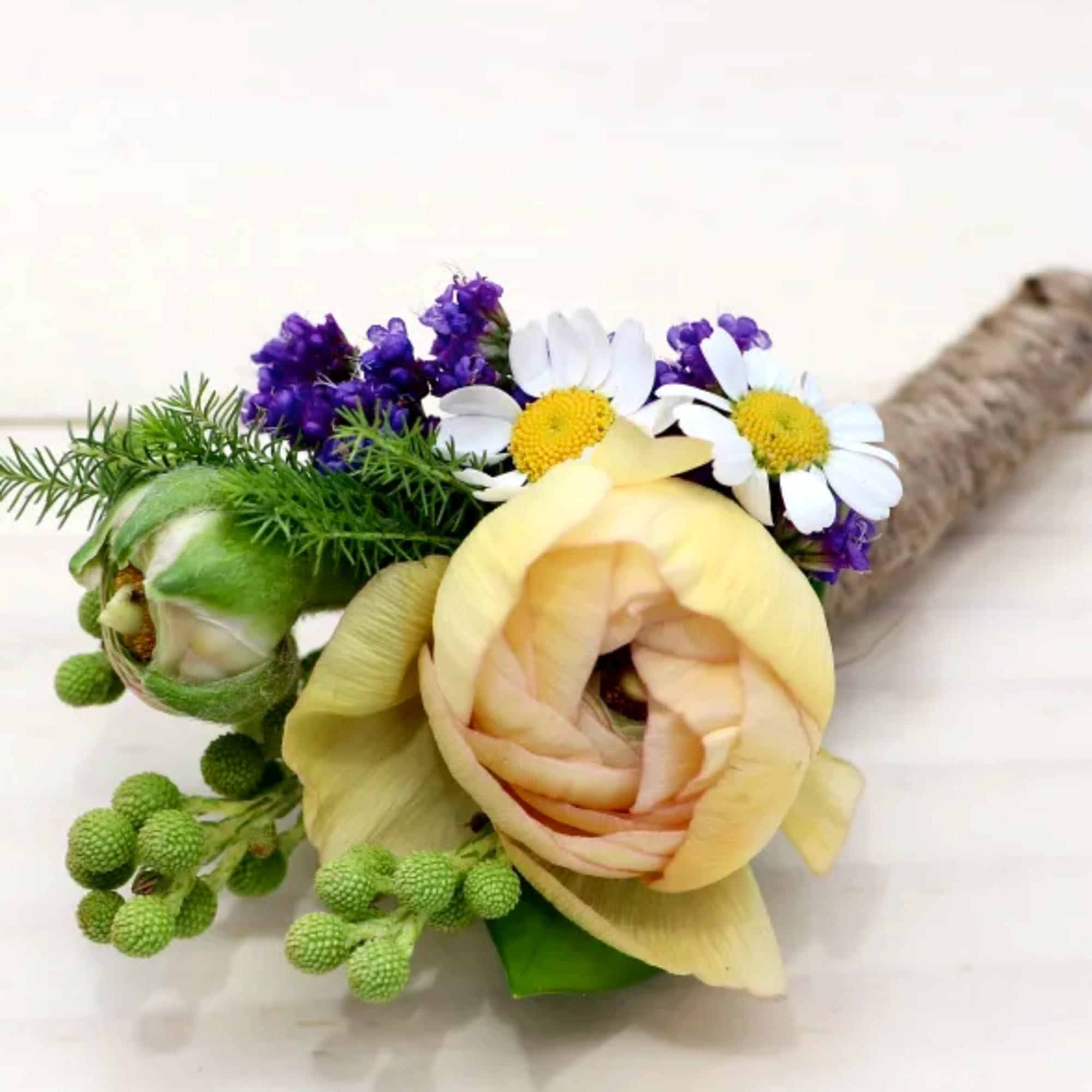 Orchid or rose boutonniere include seasonal greens, and a ribbon in the