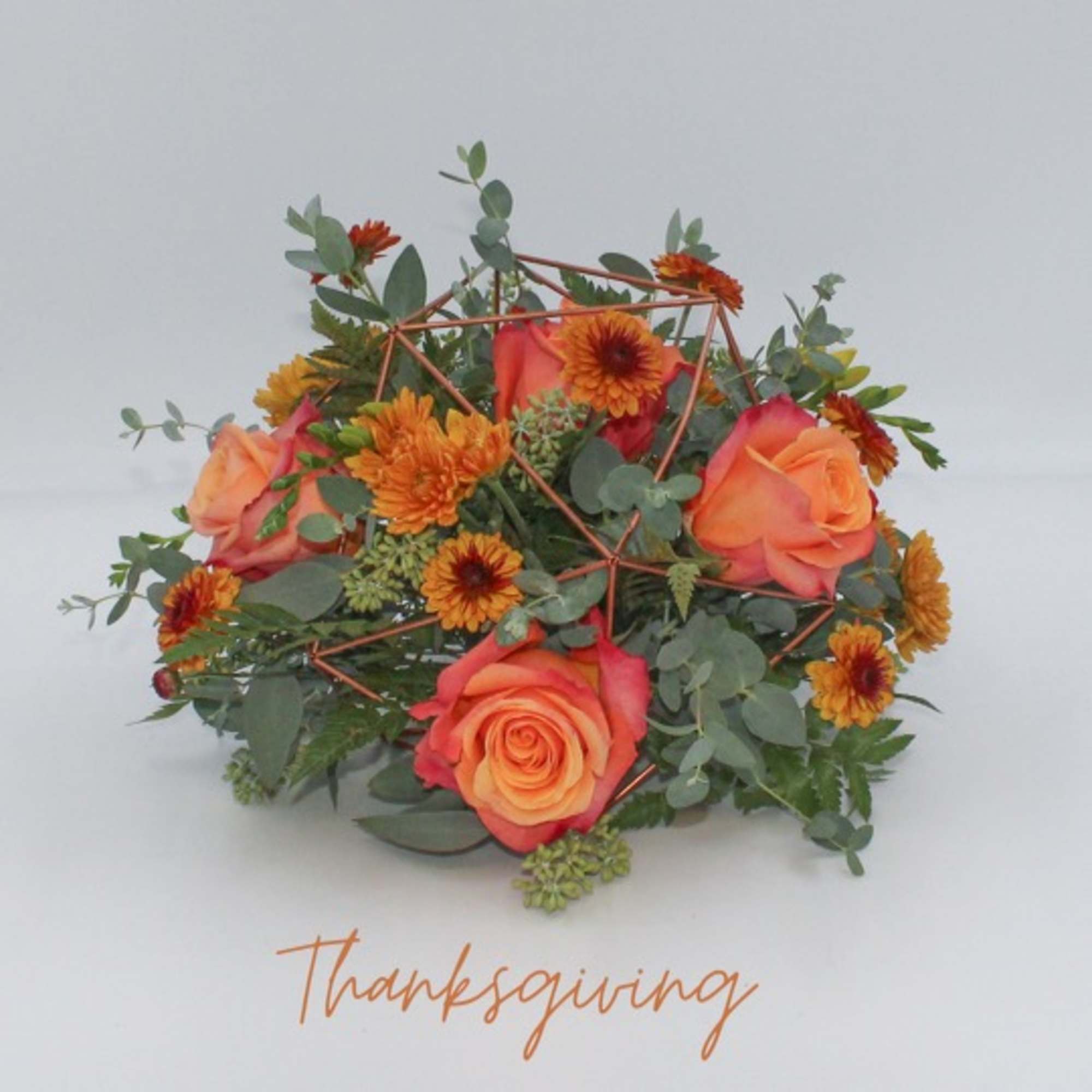 Clementine is a fun centerpiece arrangement designed in a rose gold keepsake