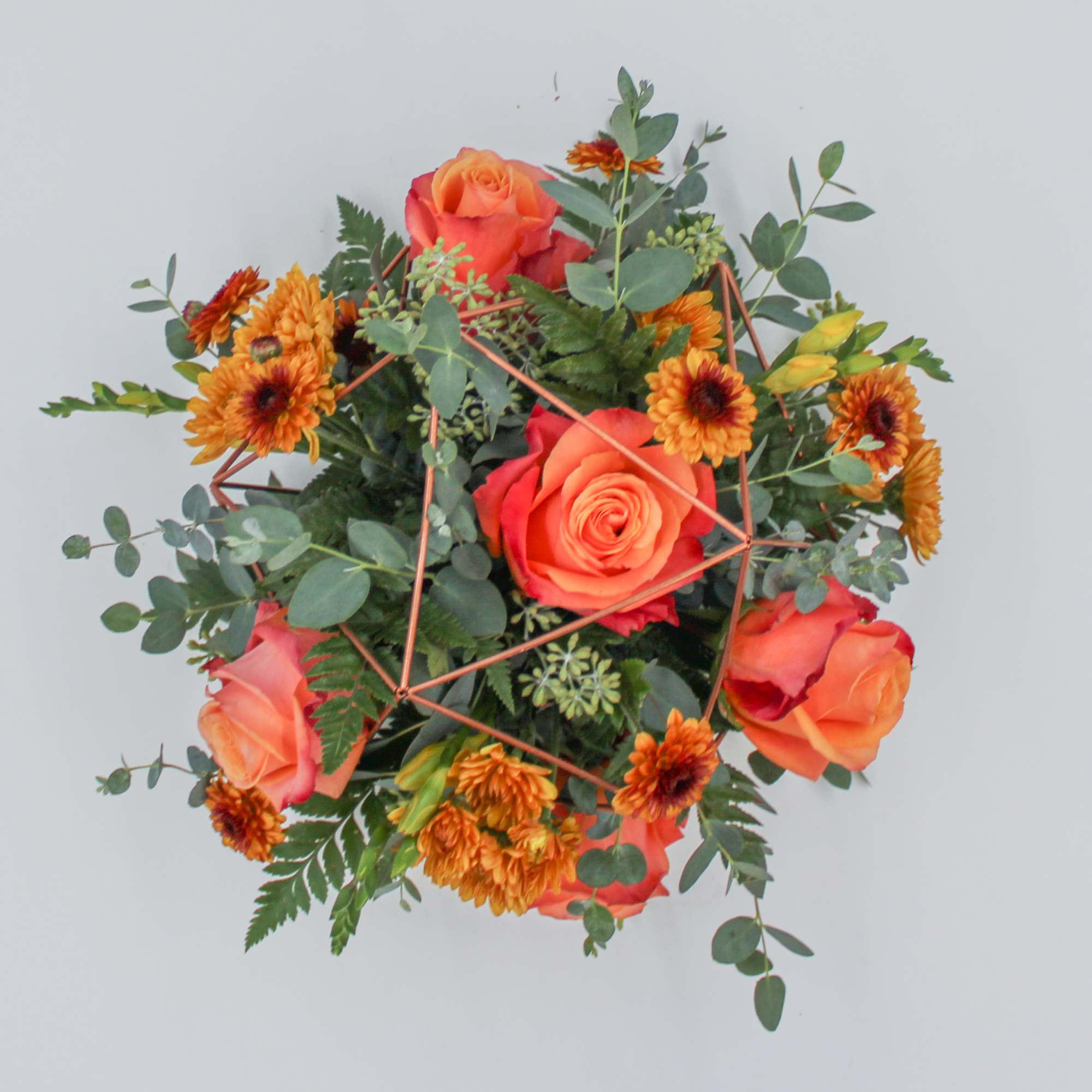 Clementine is a fun centerpiece arrangement designed in a rose gold keepsake