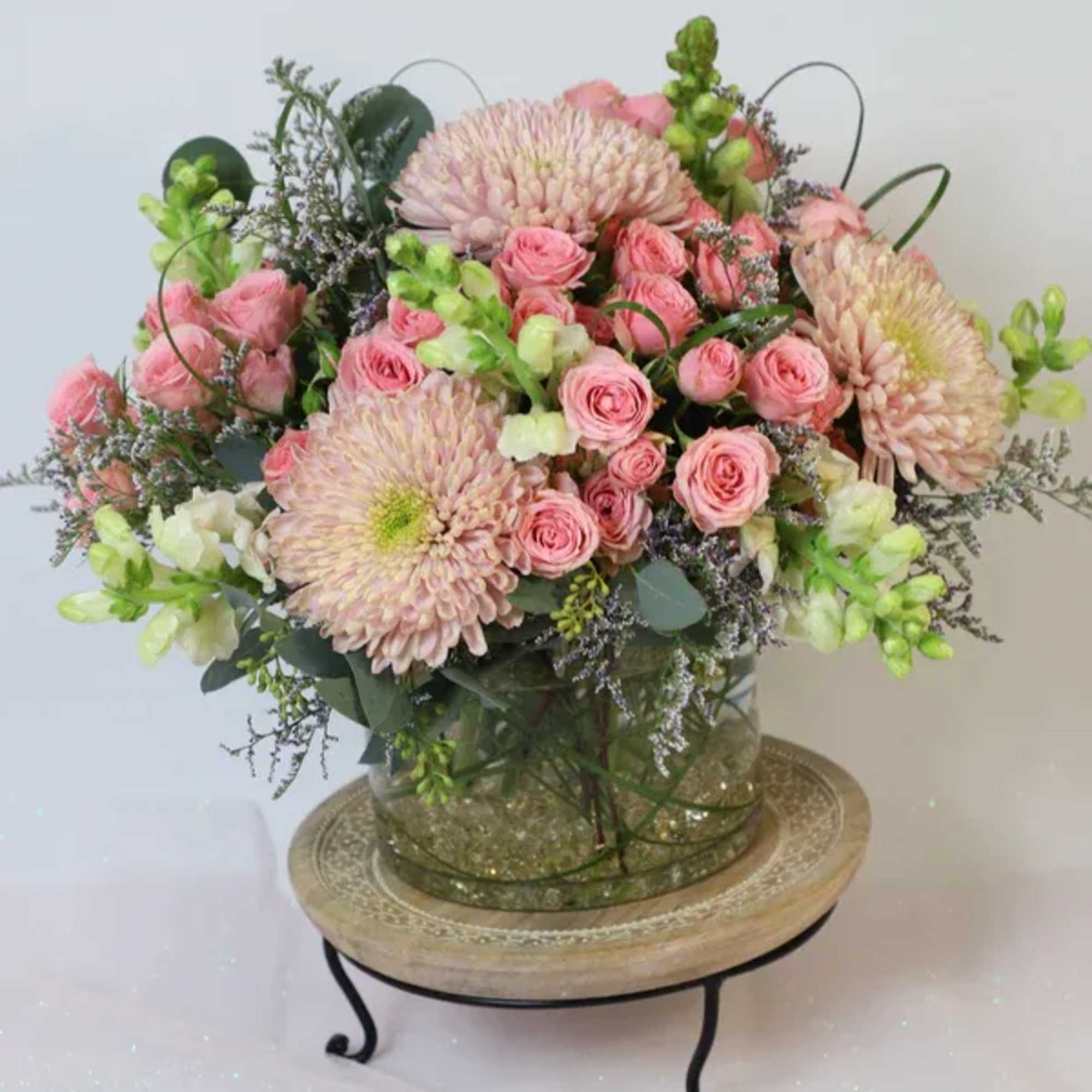 This special arrangement is made with garden roses, chrysanthemums, stock flower and