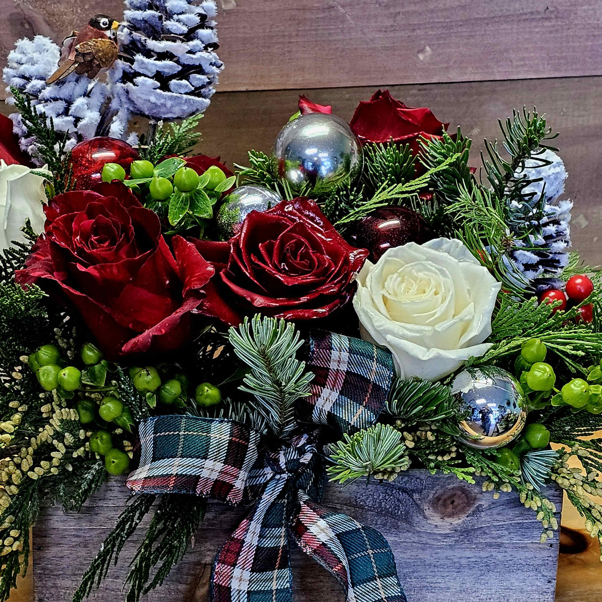 Holiday arrangement in wooden box, with roses, greens *white box is not