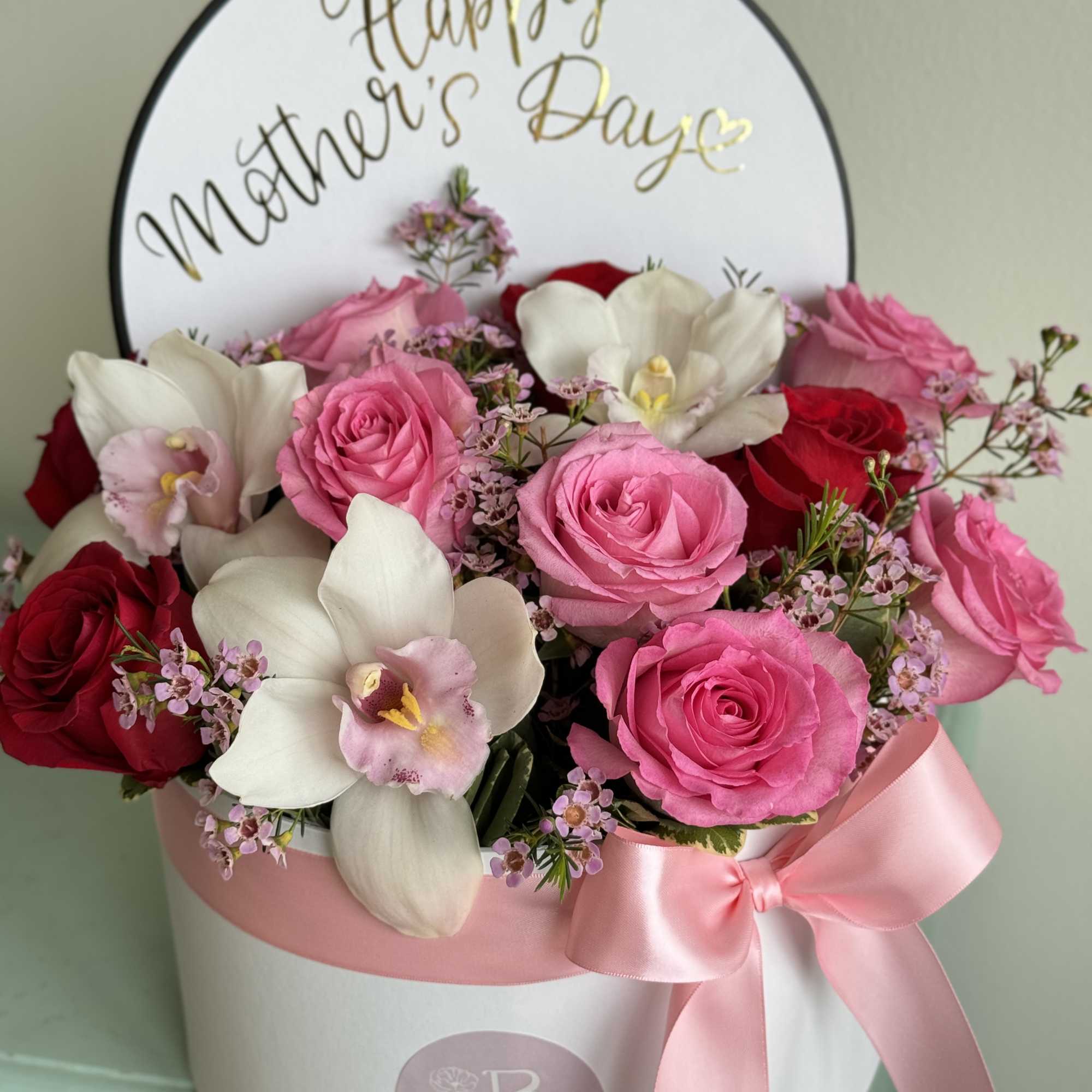 A combination of red and pink roses with beautiful cymbidium orchids. Please