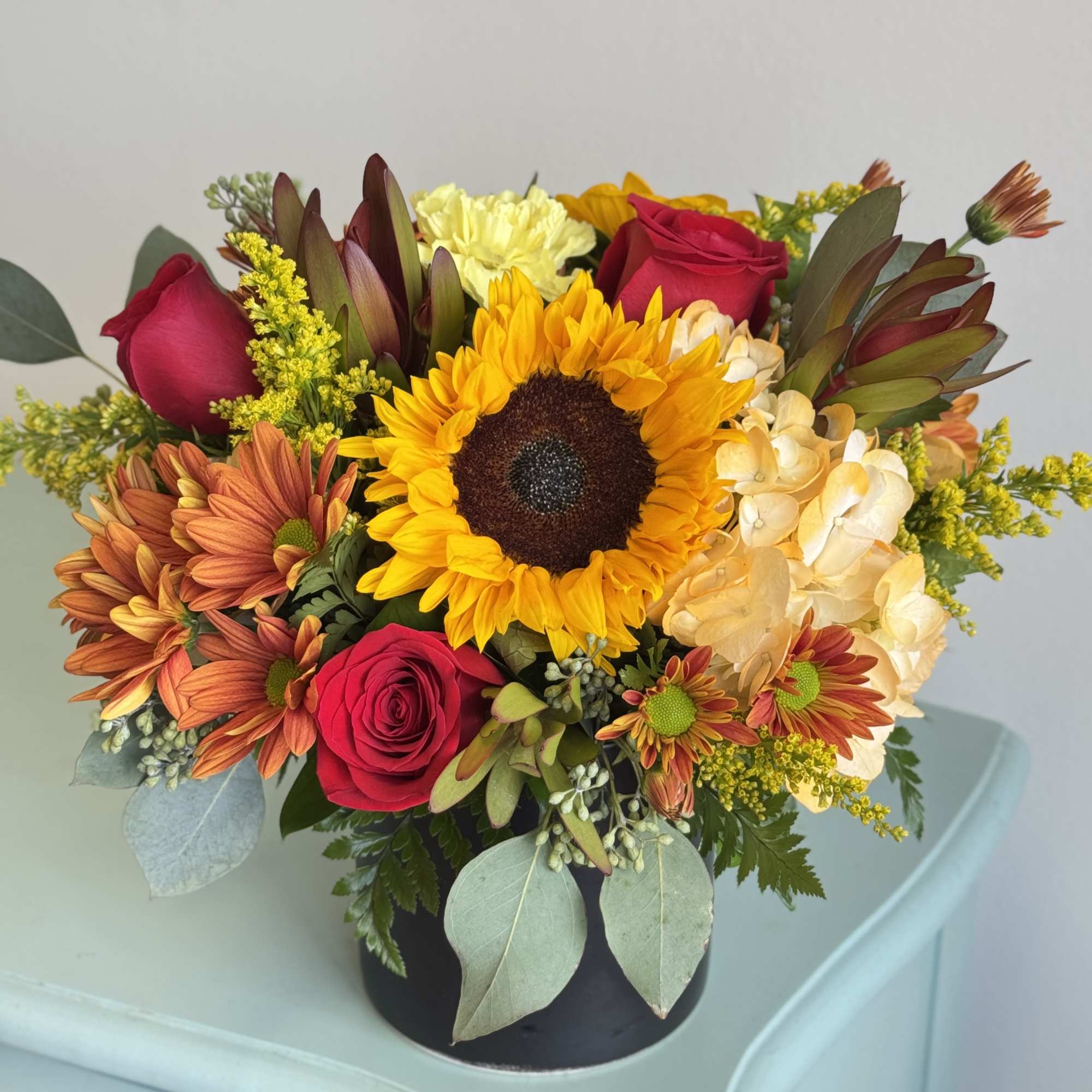 This centerpiece creates a cozy, festive feel perfect for fall gatherings.