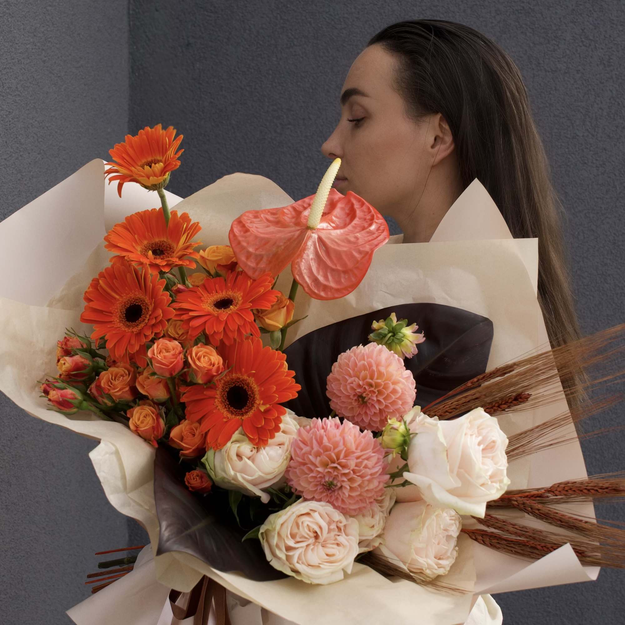 A warm harmony of orange, soft pink and brown blooms, this bouquet