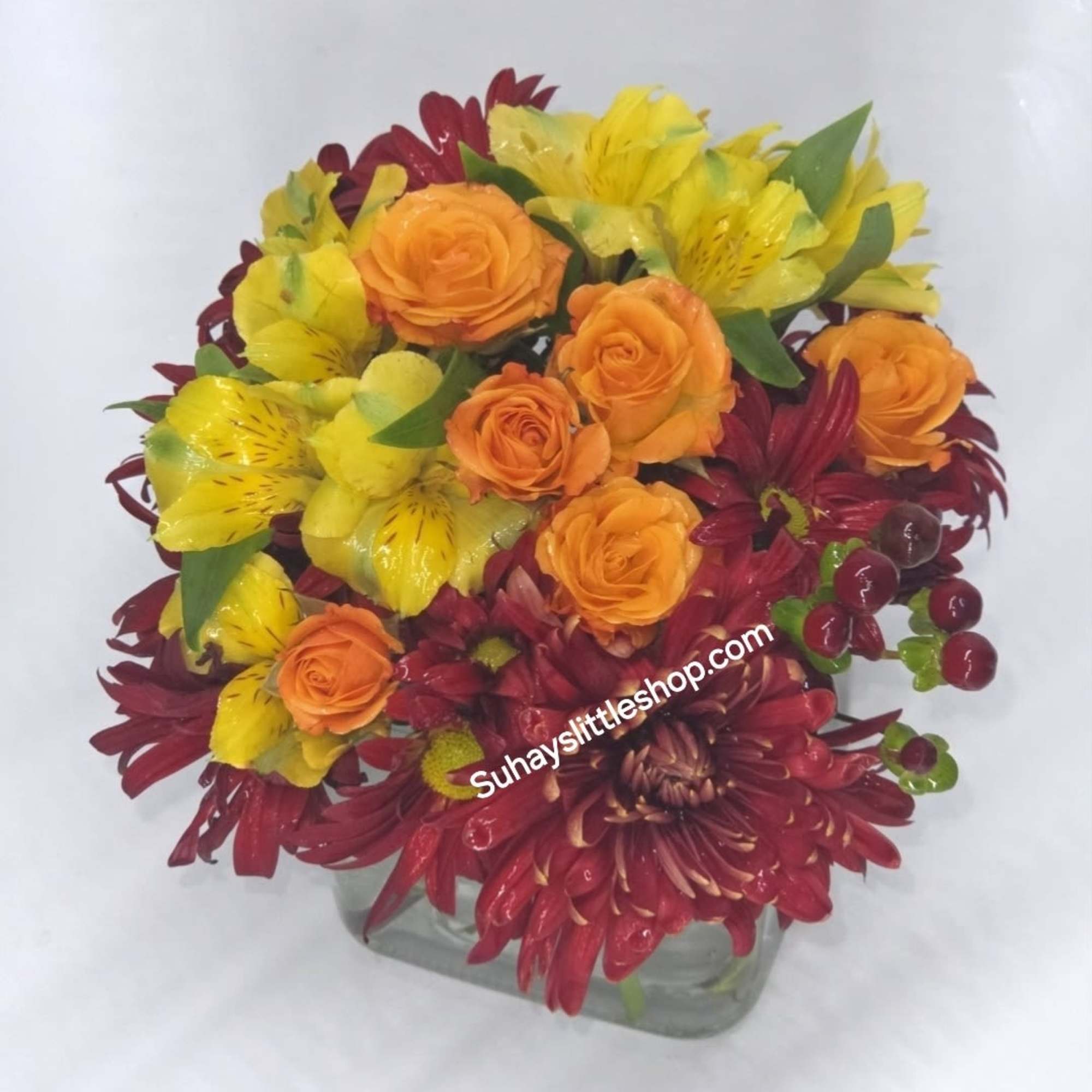 A lovely arrangement of red and orange roses mixed with delicate alstroemeria