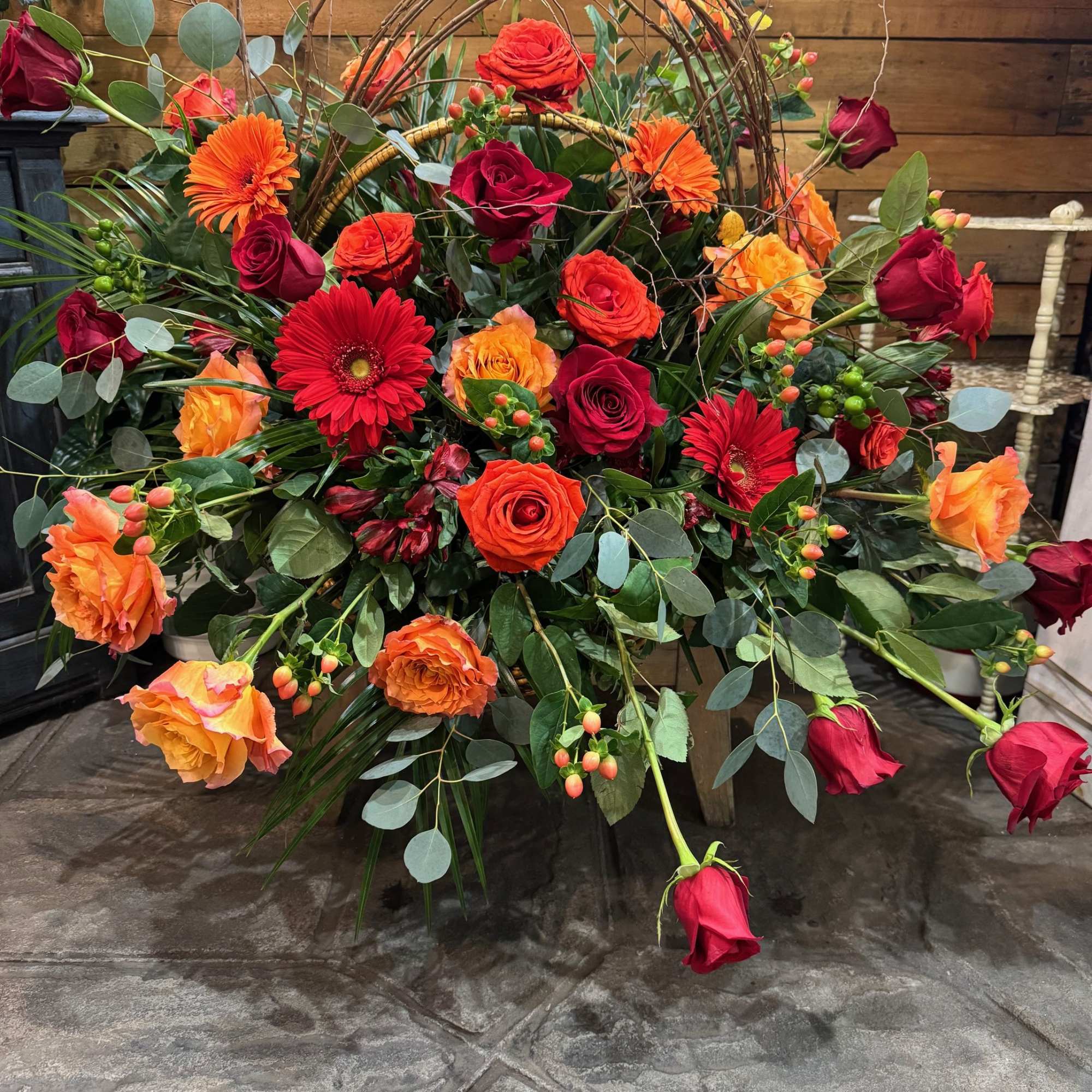 A basket full of fresh seasonal flowers cascading. Customarily for a funeral