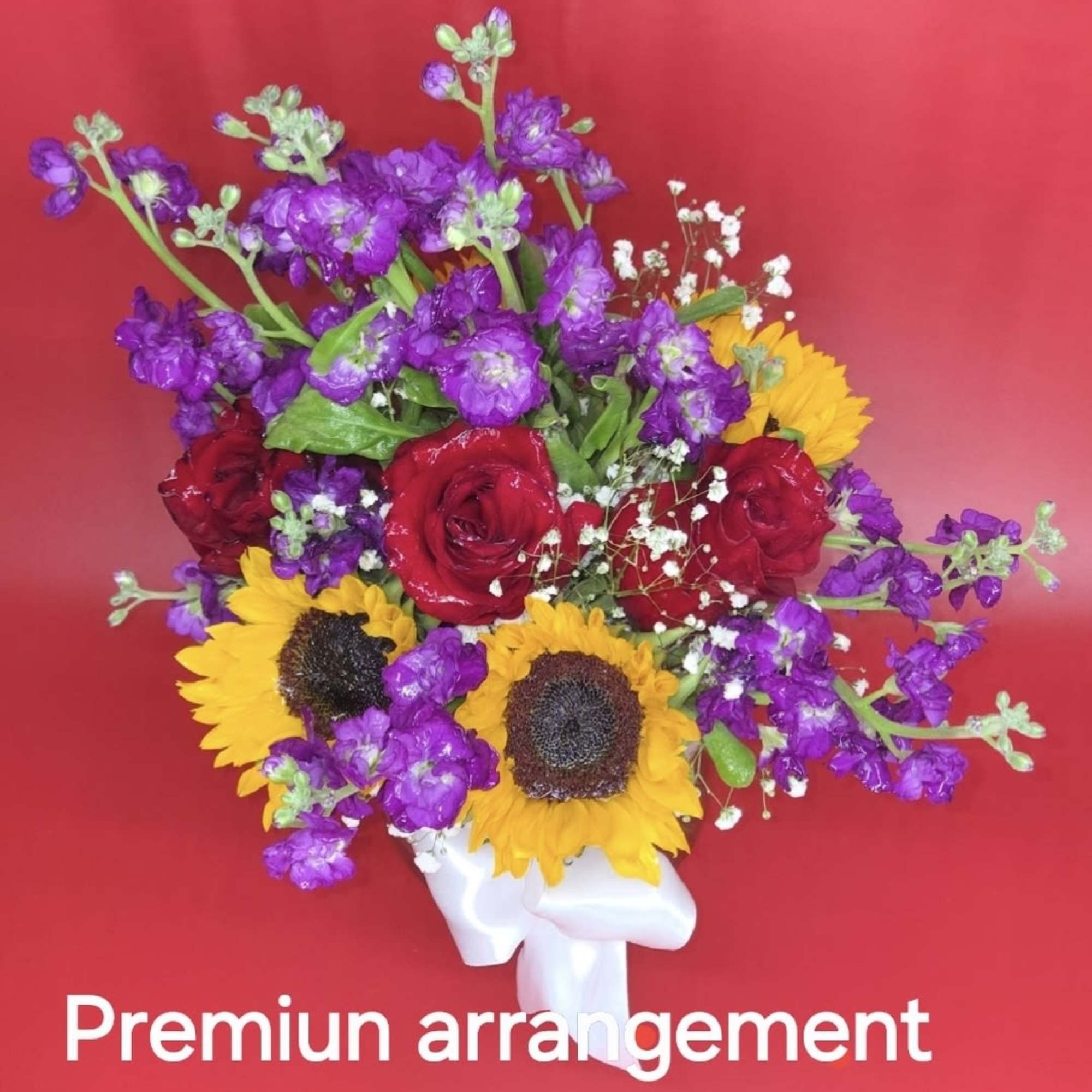 Romantic fall mood floral arrangement featuring purple-red sunflowers and warm autumn lighting.