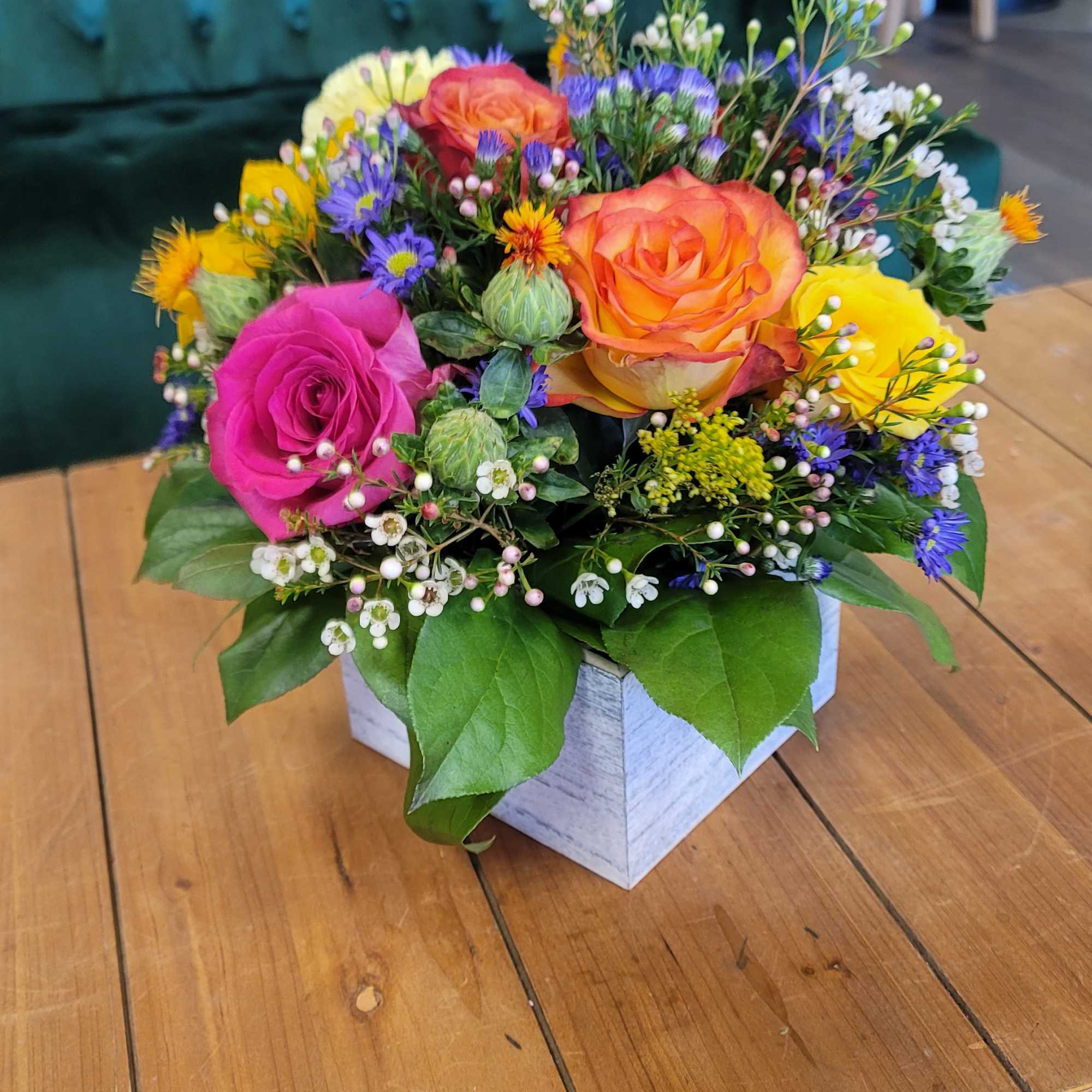 A 6x6 wooden box with a floral foam base. This has beautiful