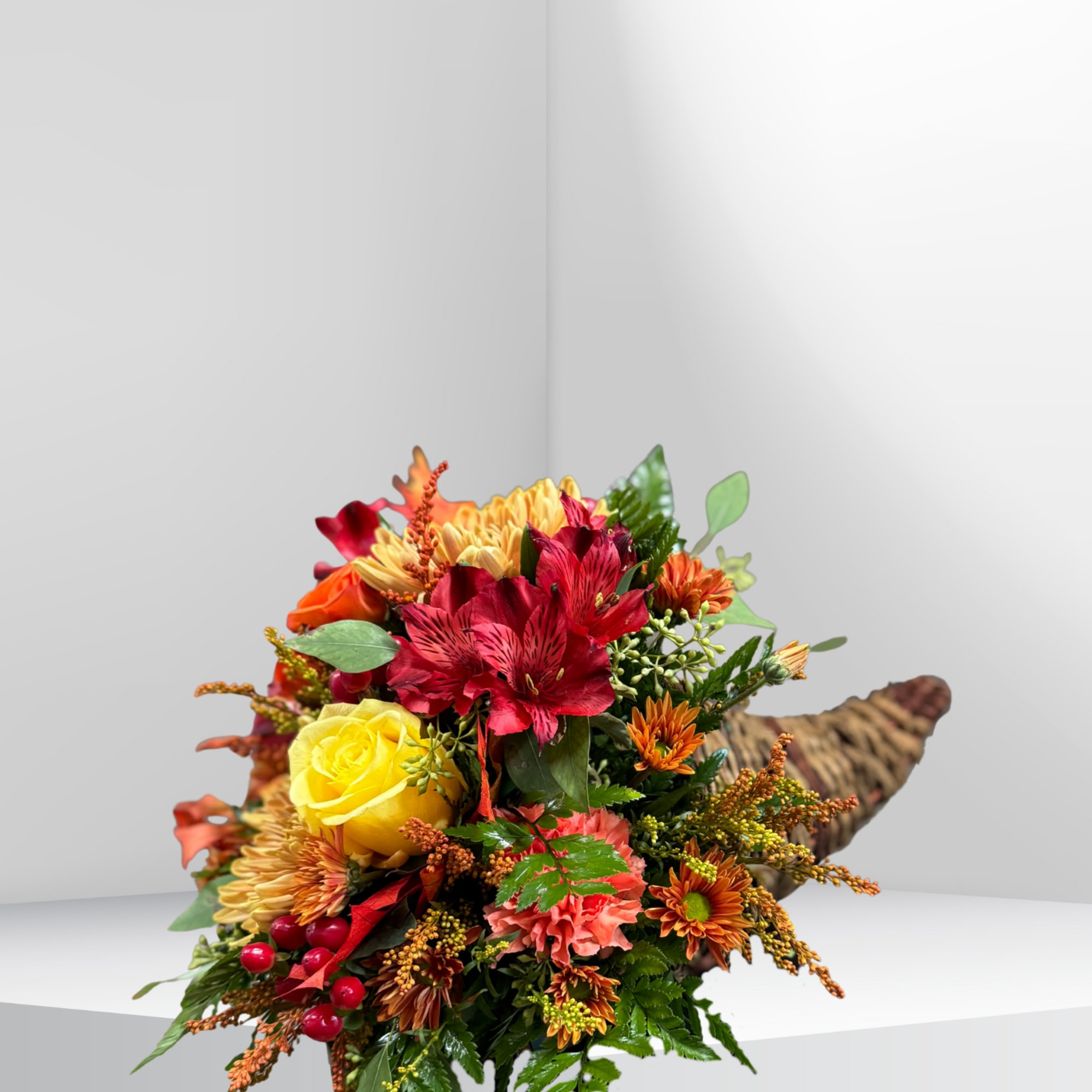 A beautiful cornucopia filled with a mix of seasonal blooms and foliage