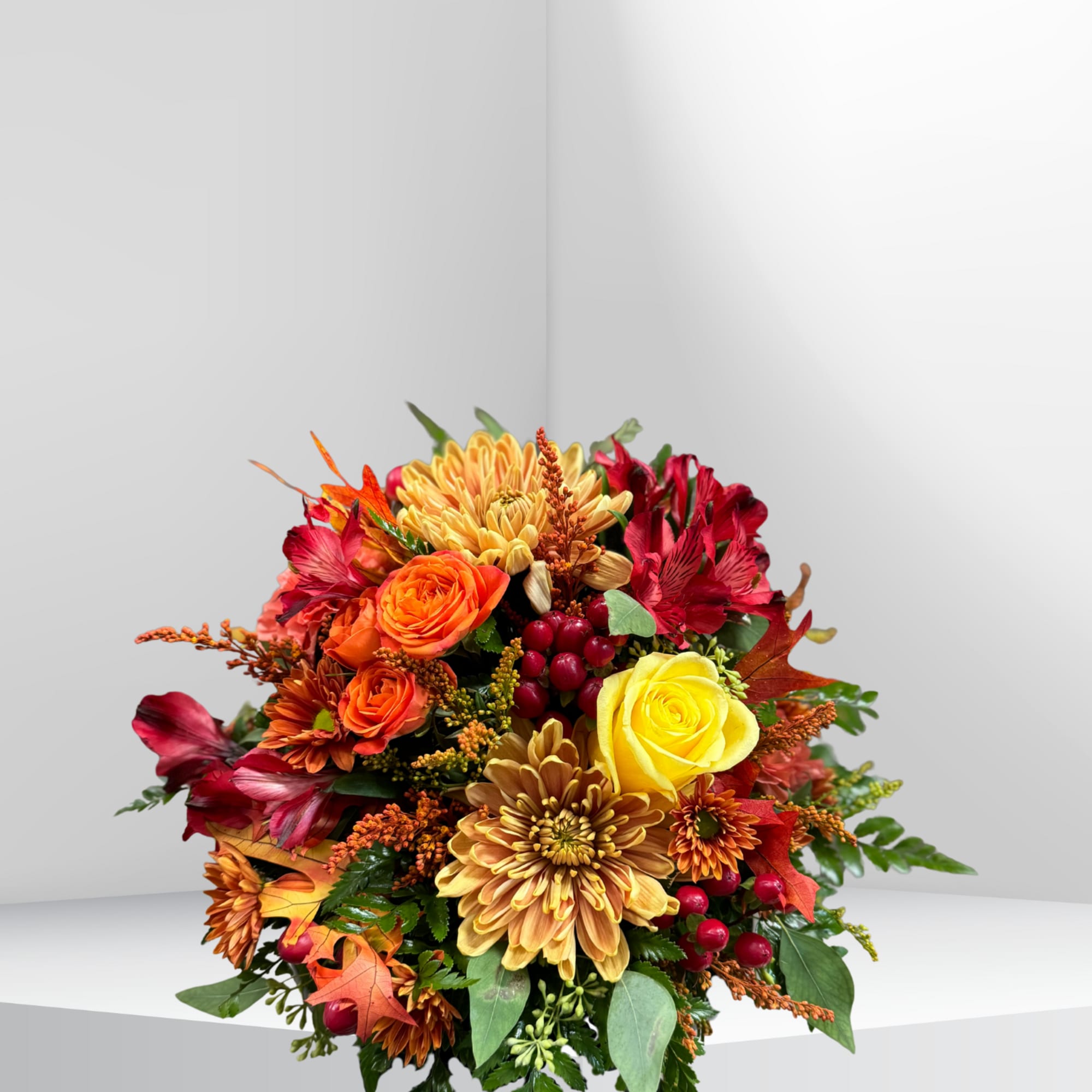 A beautiful cornucopia filled with a mix of seasonal blooms and foliage