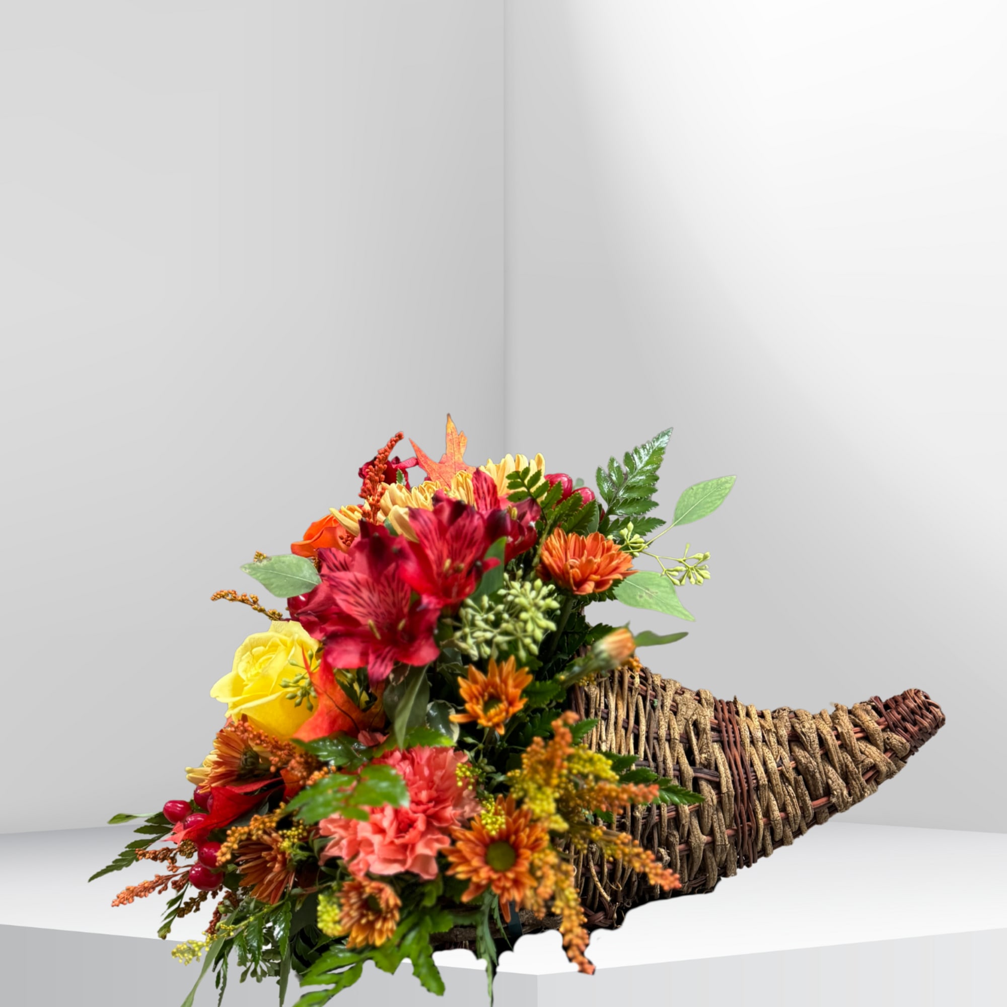 A beautiful cornucopia filled with a mix of seasonal blooms and foliage