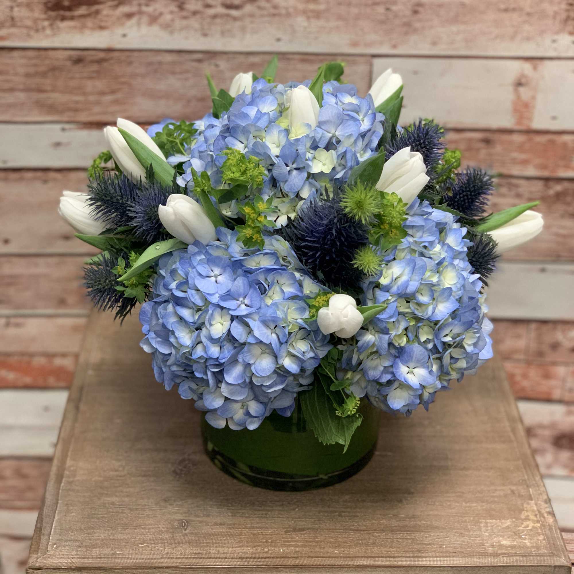 An arrangement full of a variety of blue! This arrangement will surely