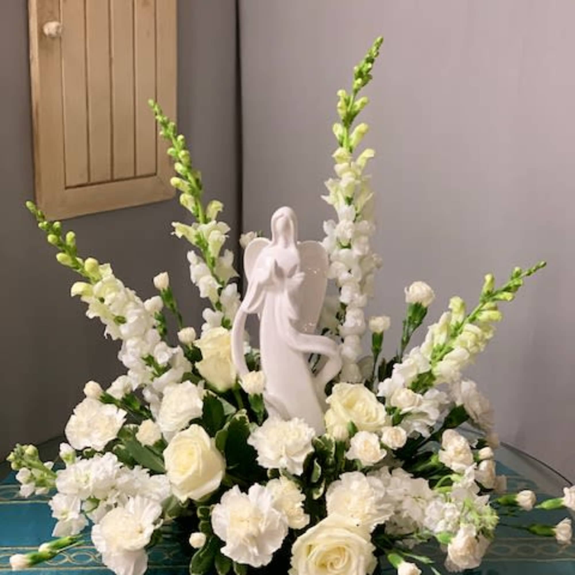 White Angel &ndash; All White Flower Arrangement
***ANGEL MAY VARY

Bring elegance, peace, and