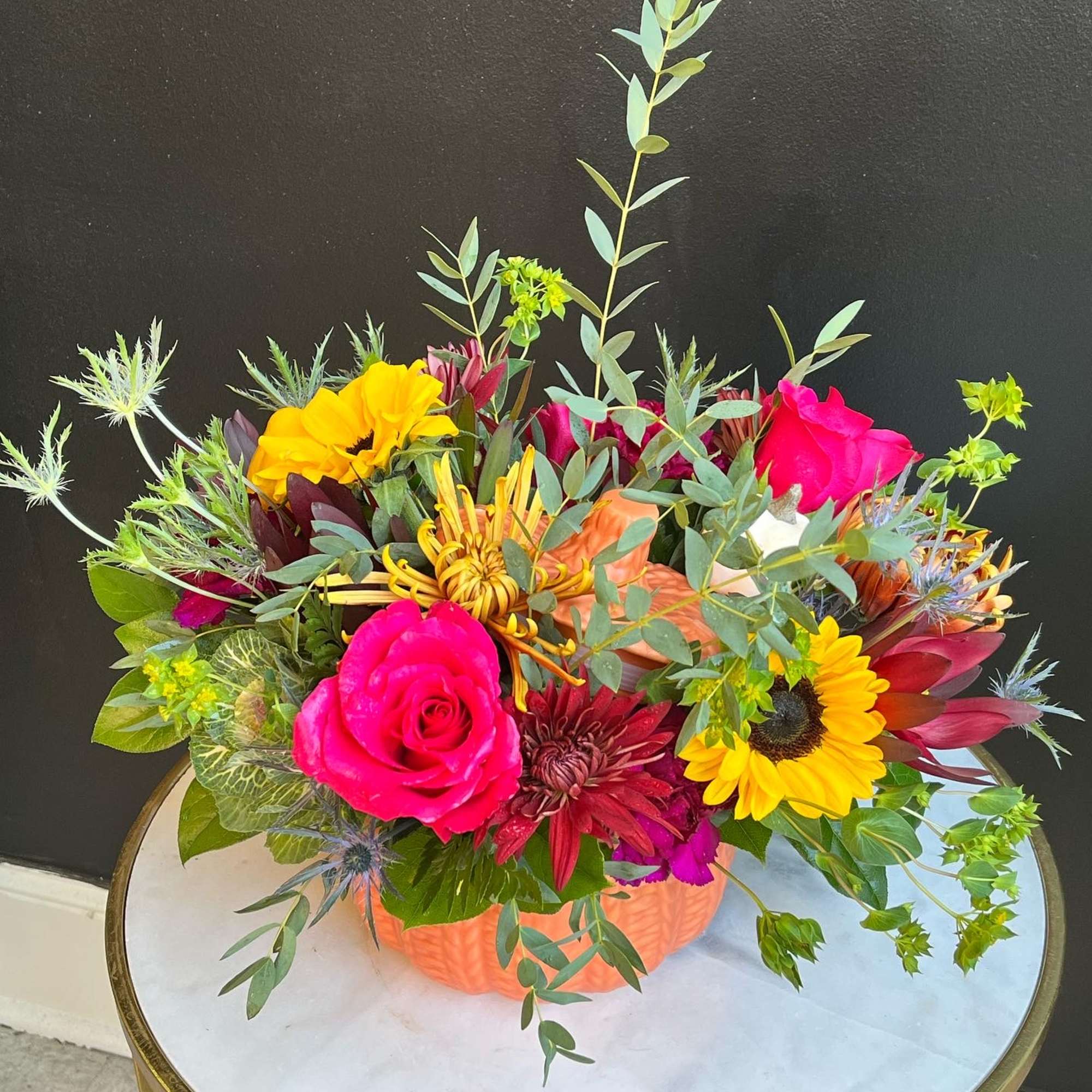 Fall assortment of Sunflowers, Leucadendron, Mums, Waxflower, Spray Roses and Assorted Greenery