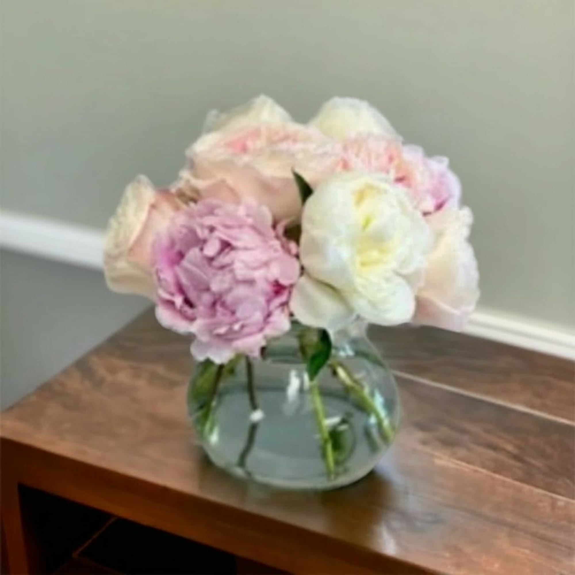 Beautiful peonies in a vase. The varieties and colors will vary from