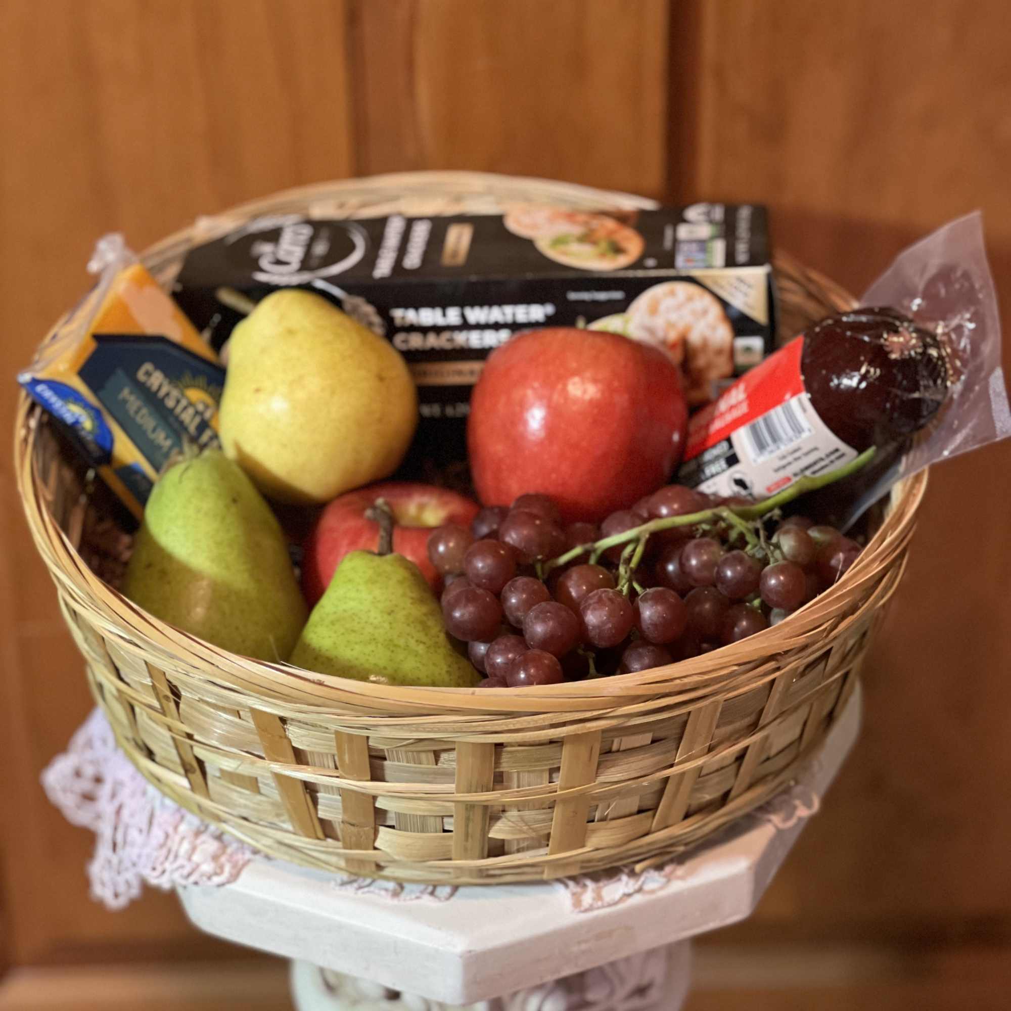 Choice seasonal fruit, cheese, crackers &amp; sausage nestled in a reusable basket.