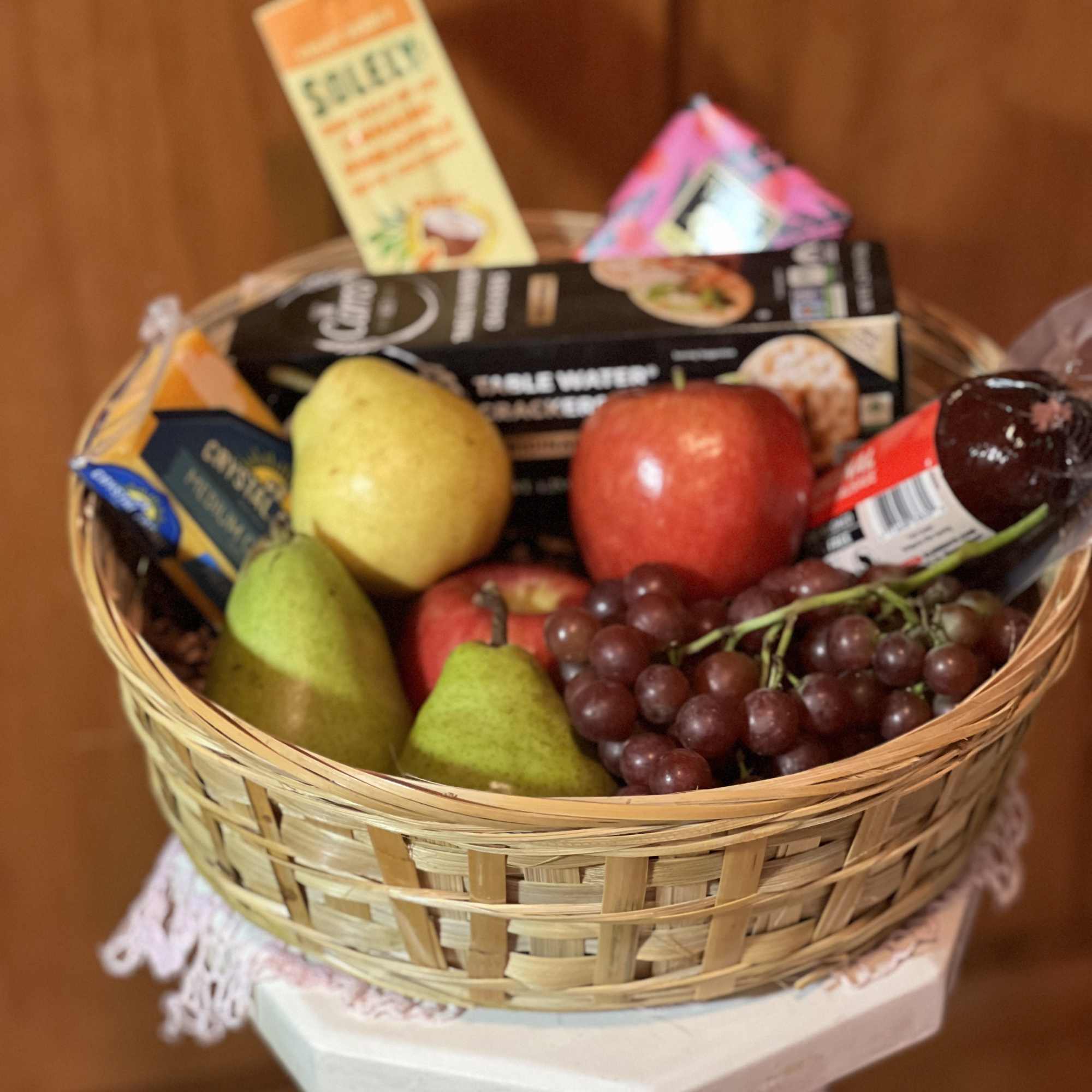Choice seasonal fruit, cheese, crackers &amp; sausage nestled in a reusable basket.